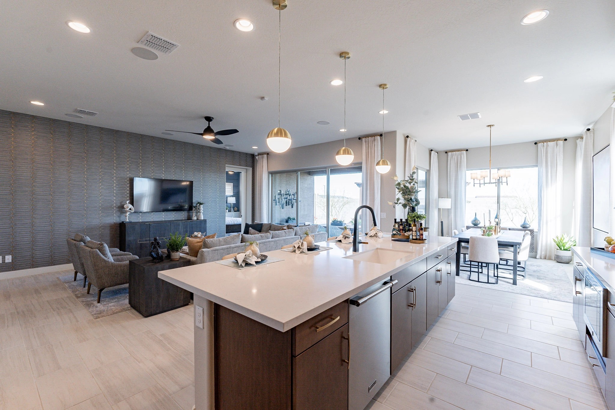 Chic Open-Plan Kitchen and Living Room in Arroyo Seco Hacienda Modern open-plan kitchen and living area with sleek cabinetry, pendant lights, and large windows. Arroyo Seco, Hacienda.