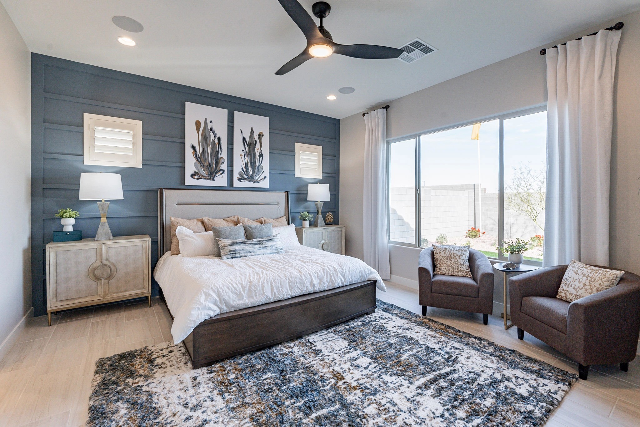 Stylish Bedroom in Arroyo Seco's Hacienda Community Elegant bedroom with accent wall, modern ceiling fan, and large window in Arroyo Seco, Hacienda community.
