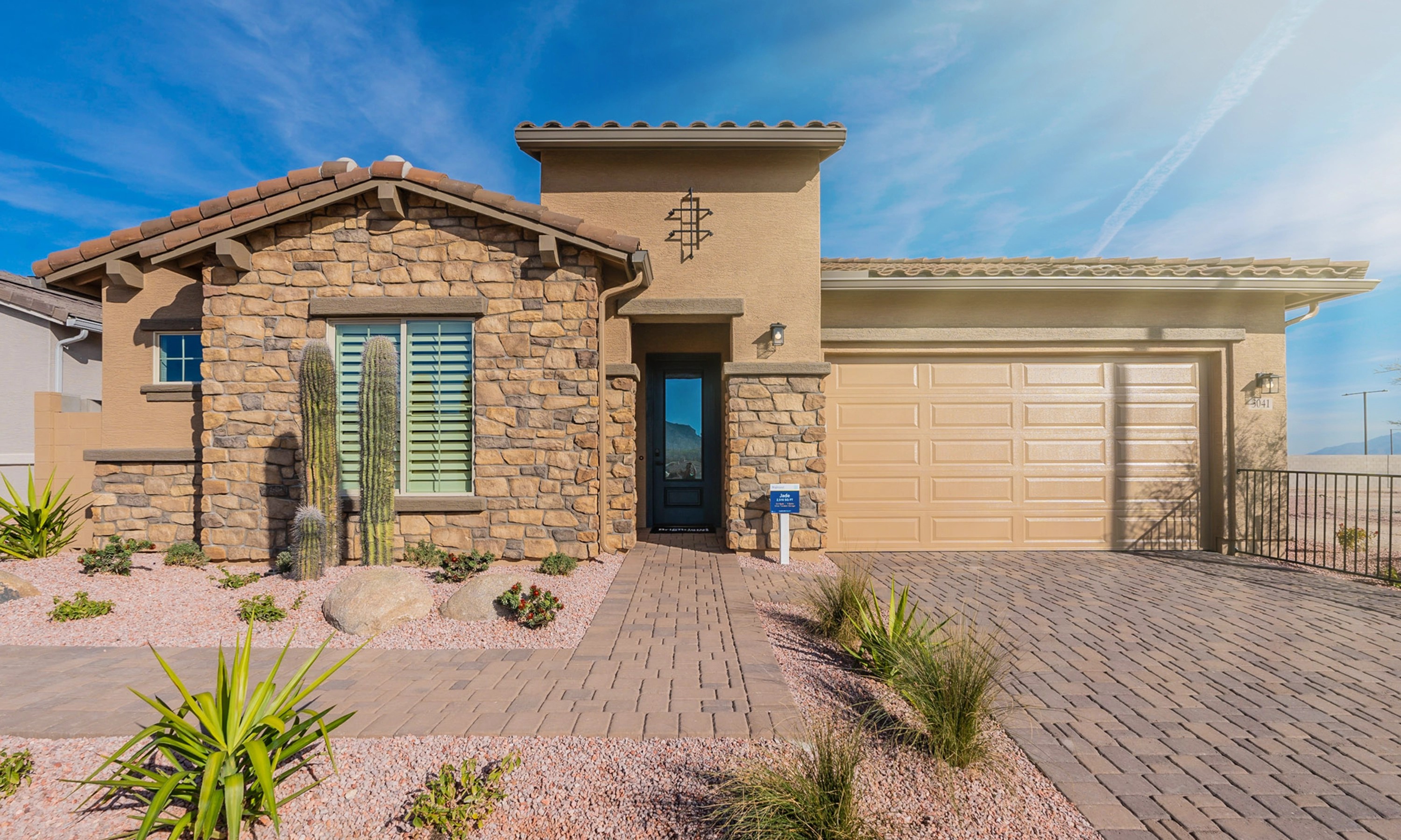 Modern Stone Facade House in Arroyo Seco Hacienda Community Modern stone facade house with tiled roof, desert landscaping, in Arroyo Seco Hacienda community.