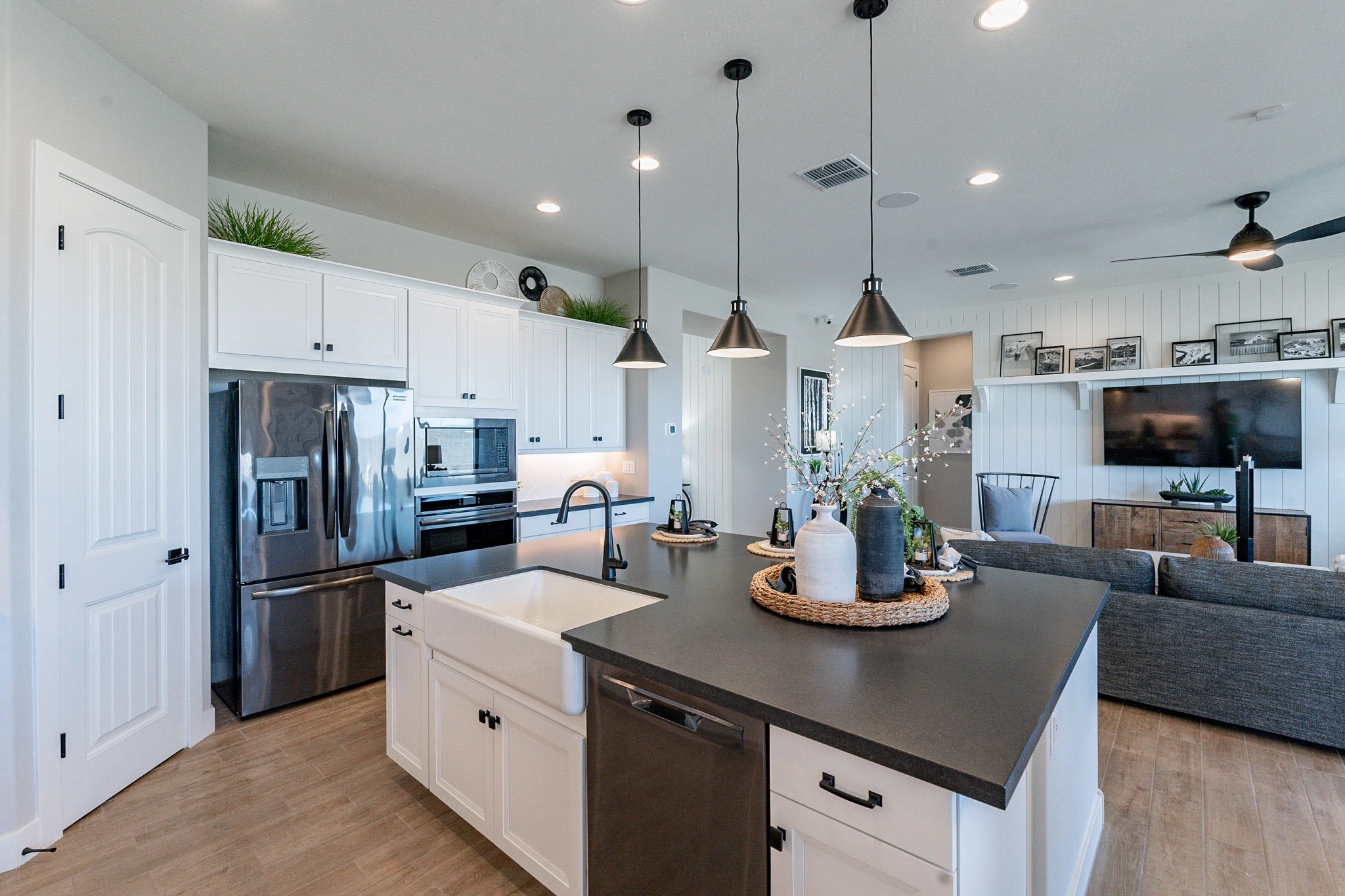 Modern Kitchen with Island in Arroyo Seco Hacienda Community Modern kitchen with island and pendant lights in Arroyo Seco home. Features stainless steel appliances, sleek design.