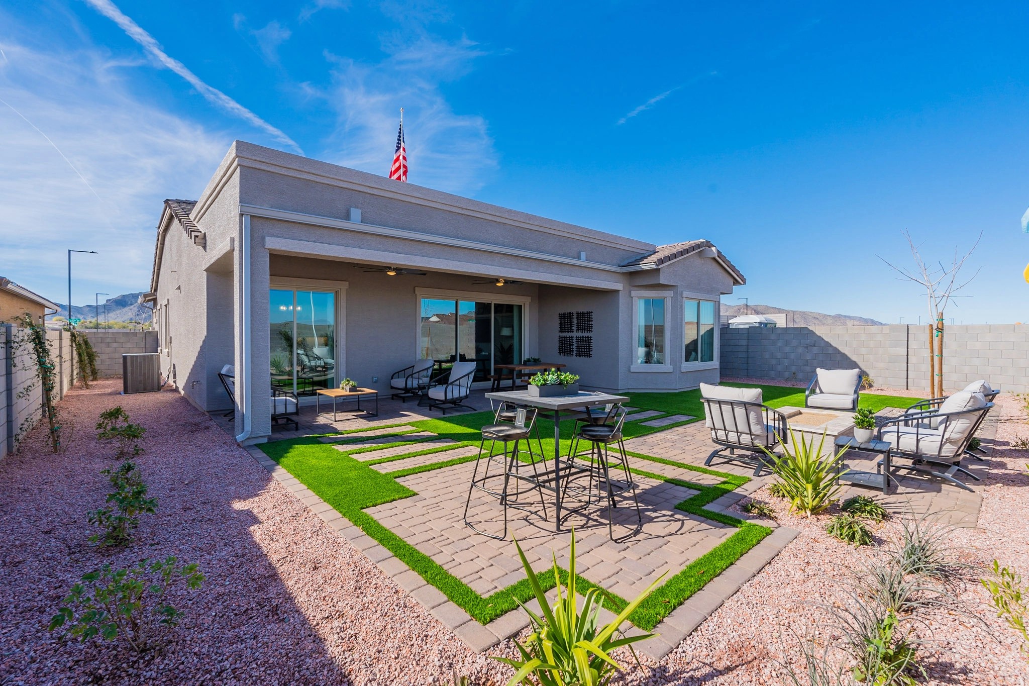 Arroyo Seco Hacienda Modern Patio with Artificial Grass and Pavers Modern patio with stylish seating, artificial grass, and pavers in Arroyo Seco Hacienda community.
