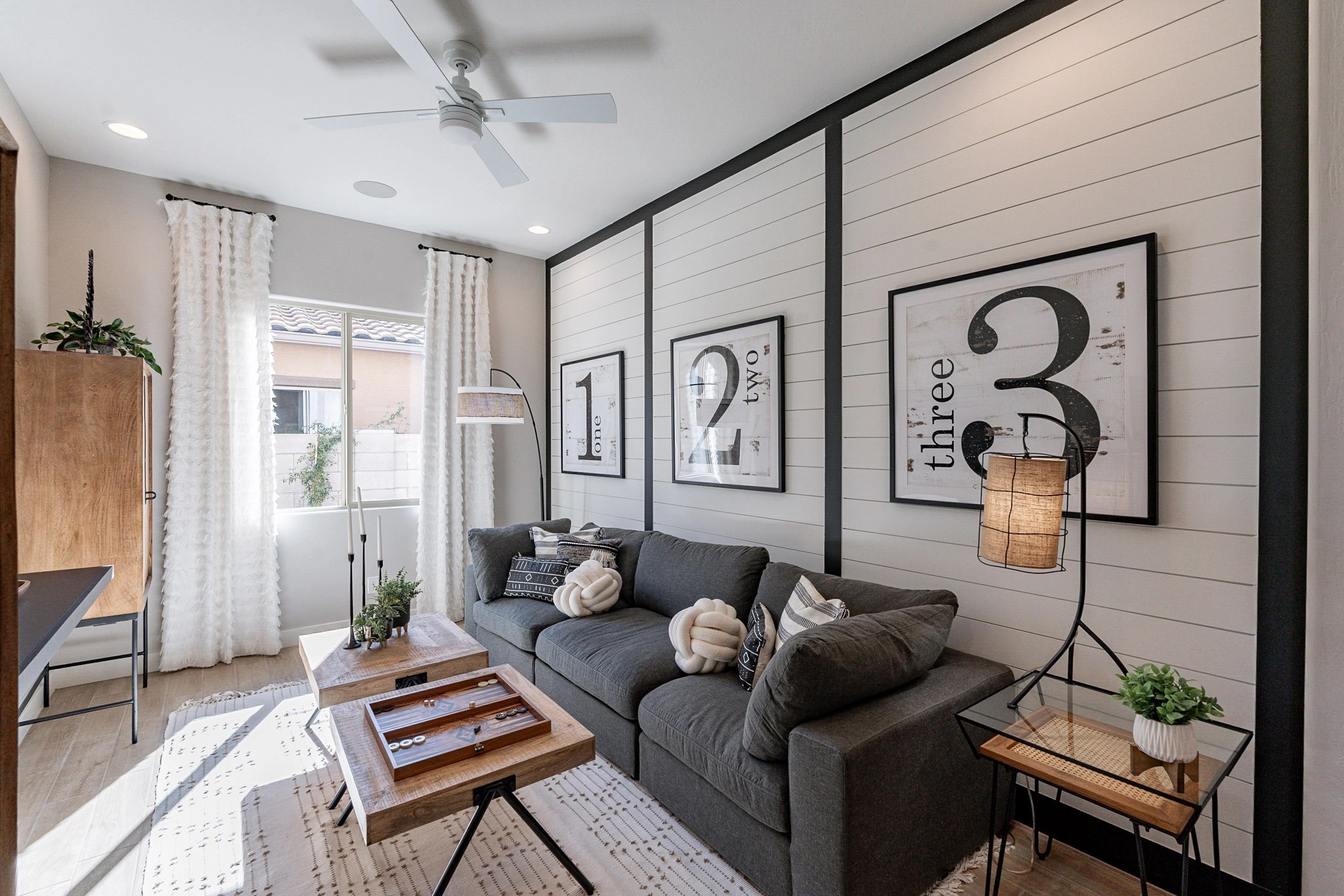 Modern Living Room with Shiplap Wall in Arroyo Seco Hacienda Cozy living room with shiplap walls, grey couch, modern decor, wood tables, Arroyo Seco Hacienda.