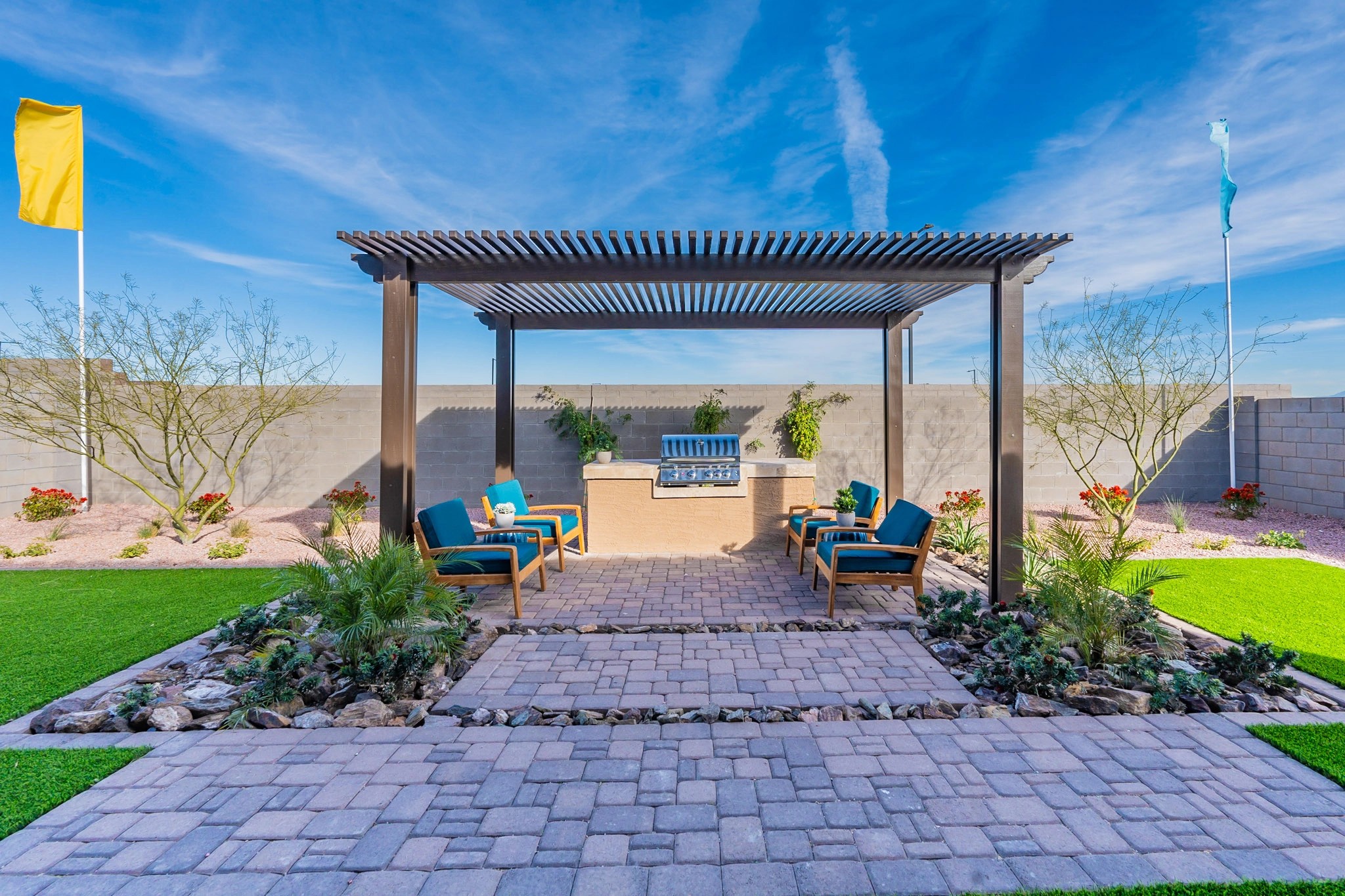 Outdoor Patio with Pergola in Arroyo Seco Hacienda Backyard patio with pergola, outdoor seating, grill, and desert landscaping in Arroyo Seco Hacienda.