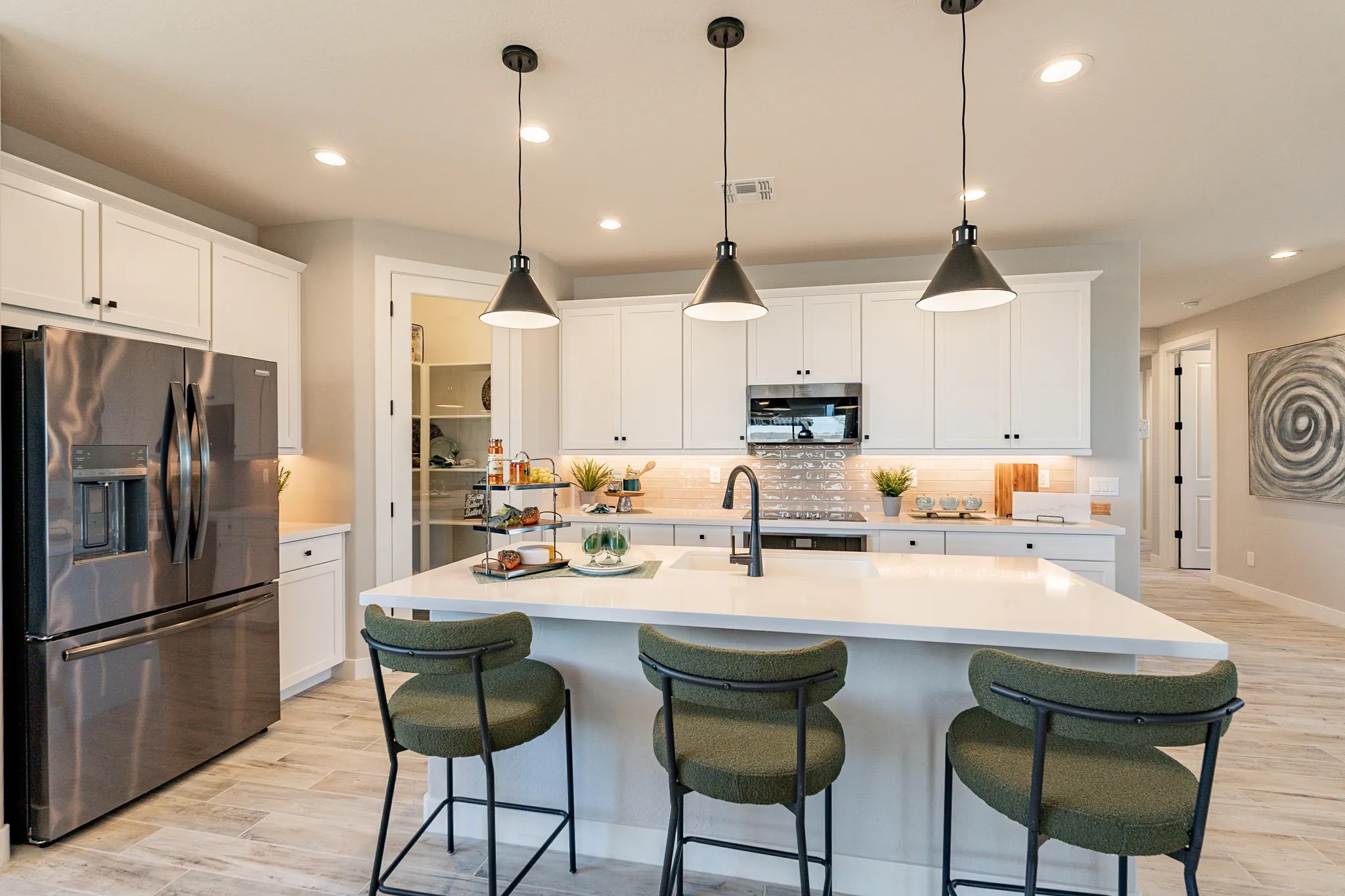 Luxury Kitchen Design in Sienna Park with Modern Features Modern kitchen in Sienna Park with white cabinets, stone countertop, pendant lights, and stainless steel appliances.