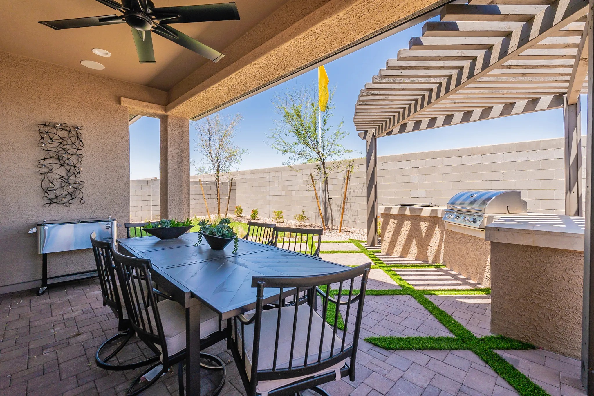 Sienna Park Outdoor Dining Area with Pergola and Grill Outdoor dining area with modern pergola, grilling station, and stone patio in Sienna Park community.