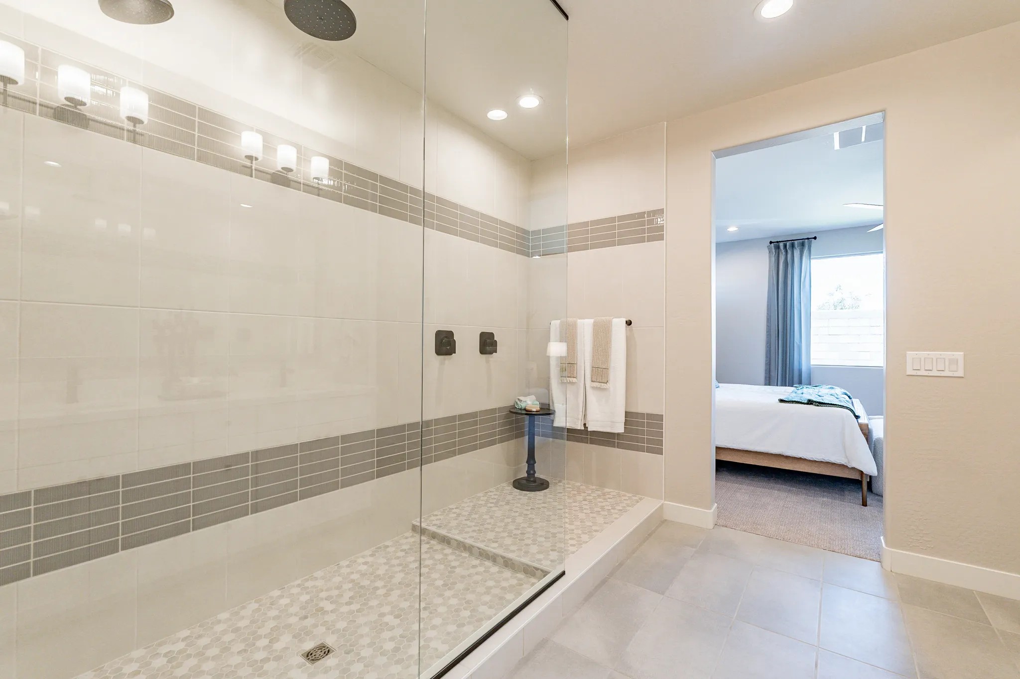 Modern Walk-In Shower in Sienna Park Luxury Home Spacious walk-in shower with modern tiles in luxury Sienna Park home. Bedroom visible through doorway.