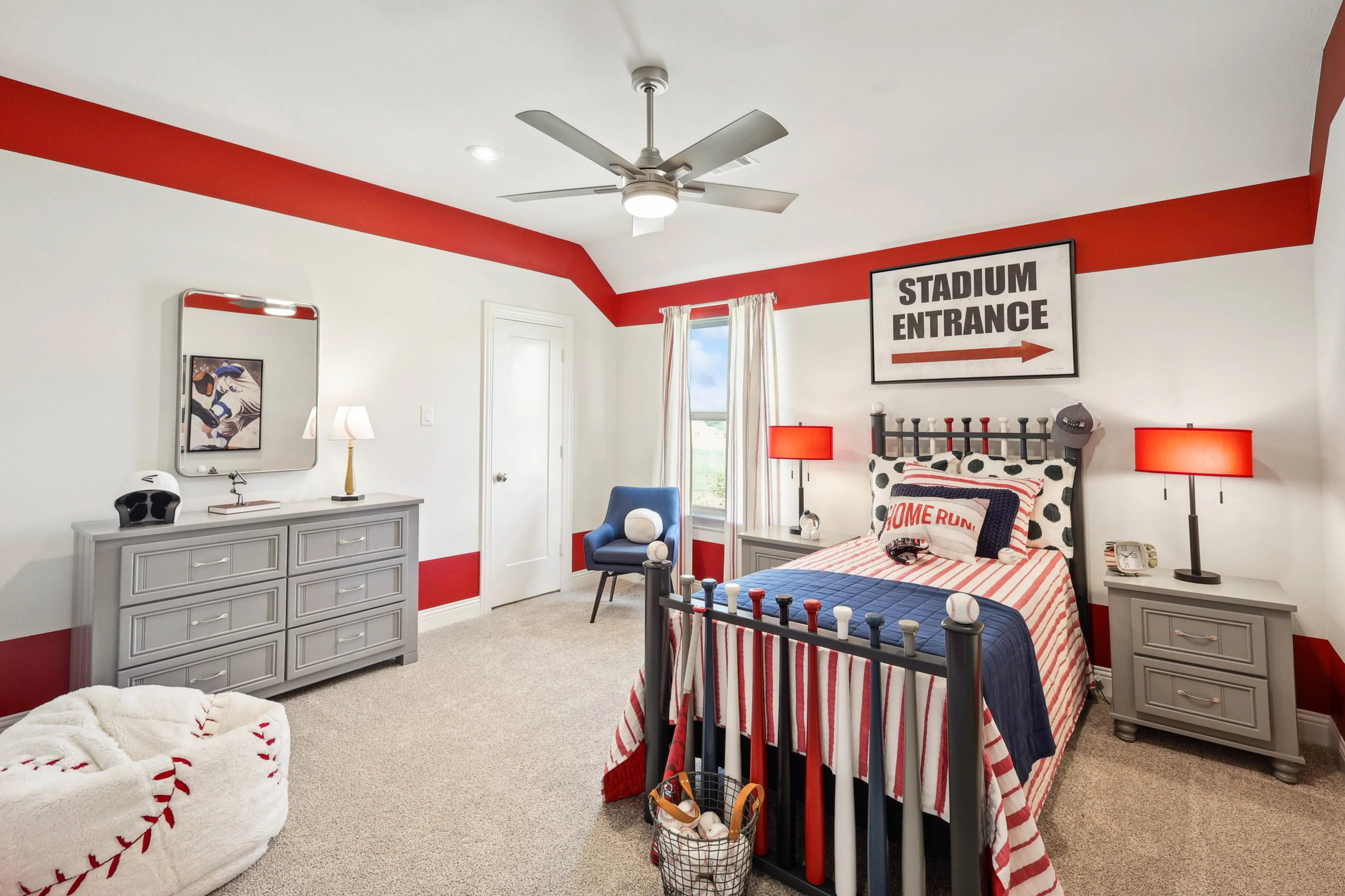 Baseball-Themed Bedroom with Red Accents in Ridge Crossing Community Baseball-themed bedroom, vibrant red accents, modern ceiling fan, Ridge Crossing community location, sporty decor.