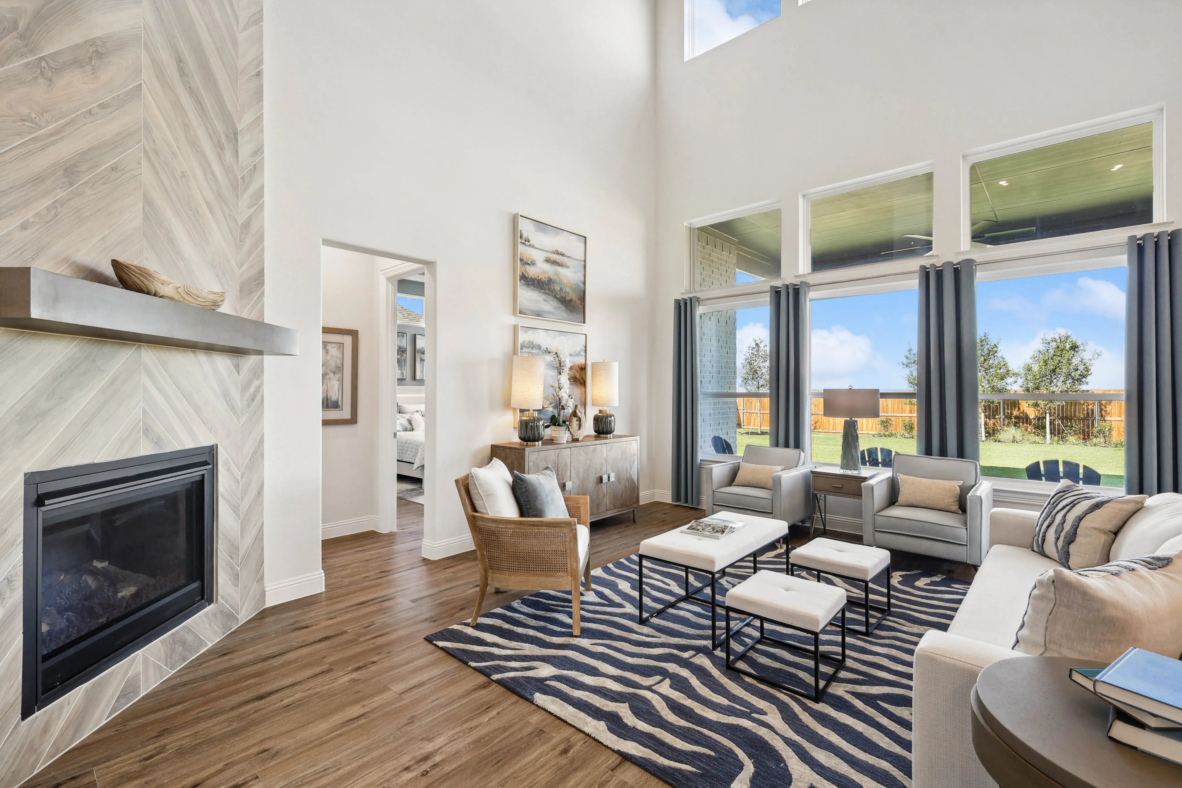 Ridge Crossing Living Room with High Ceilings and Modern Decor, Texas Spacious Ridge Crossing living room, high ceiling, large windows, stylish fireplace, elegant modern decor, Texas.