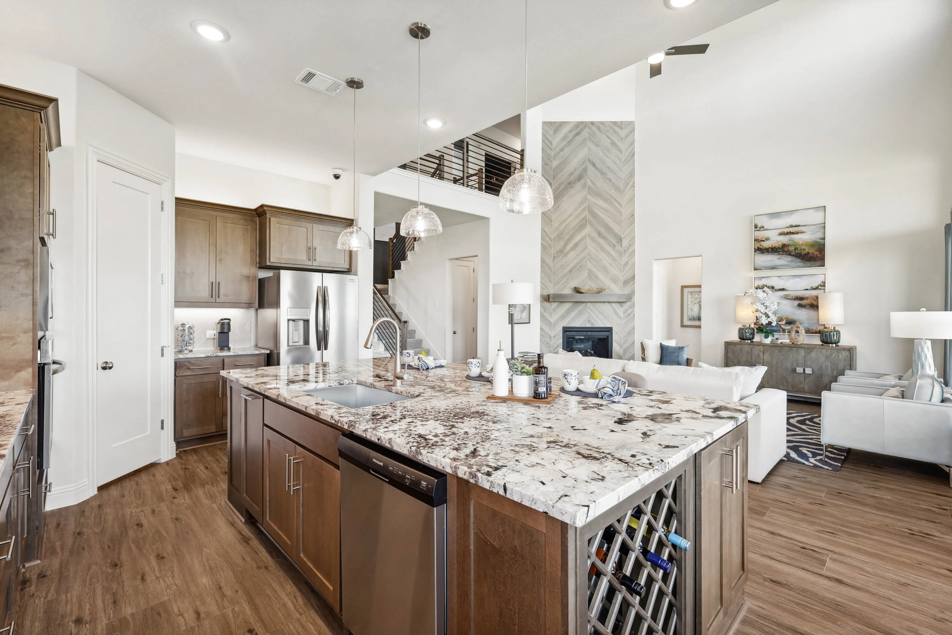 Ridge Crossing Luxury Kitchen with Marble Island and Wood Flooring Luxurious open-concept kitchen with marble island, wood floors, Ridge Crossing home, pendant lighting.