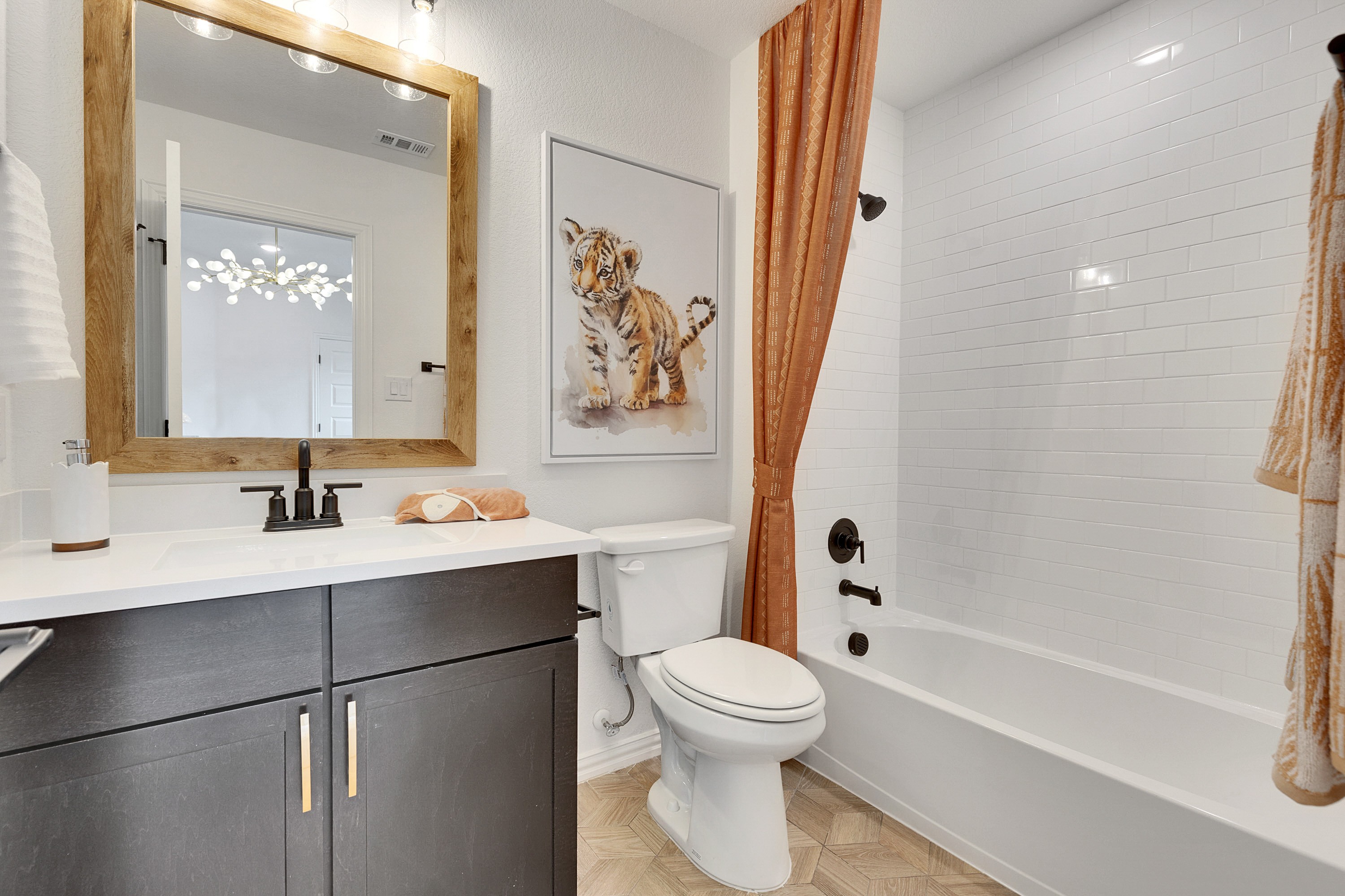 Elegant Bathroom Design with Wooden Accents in Spring Creek Modern bathroom with wooden framed mirror, tiger artwork, and elegant dark vanity, Spring Creek.