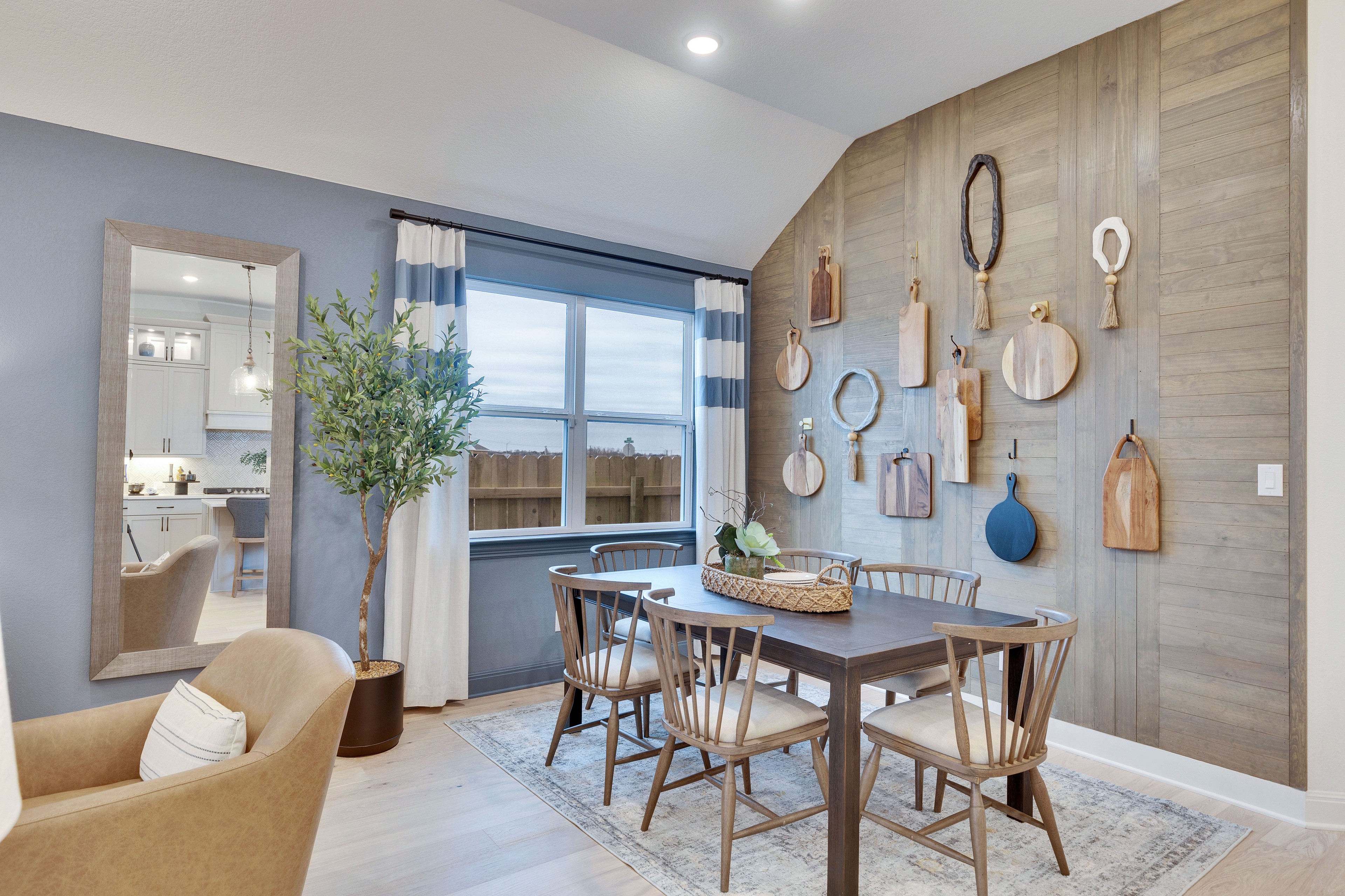 Modern Dining Area with Wood Accent Wall in Spring Creek Community. Elegant dining area with wood accent wall, modern decor, in Spring Creek community.