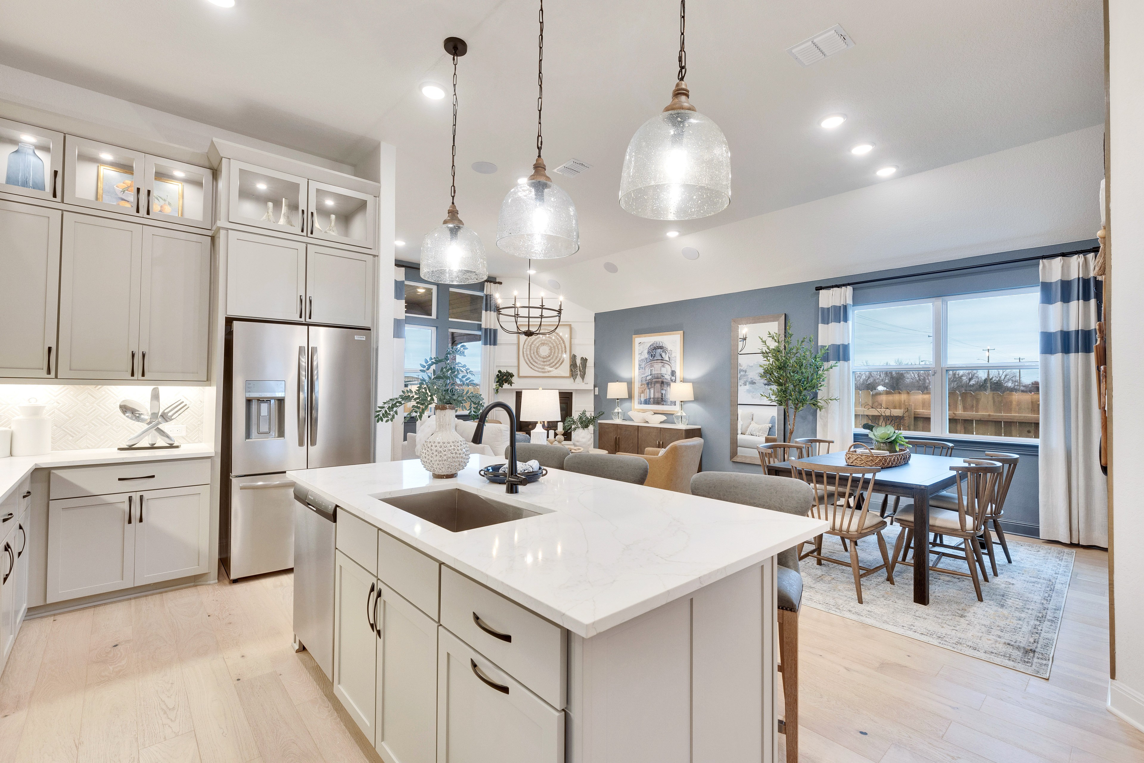 Elegant Kitchen Features in Spring Creek Community Home Luxury kitchen with marble island, custom cabinetry, pendant lights in Spring Creek home.
