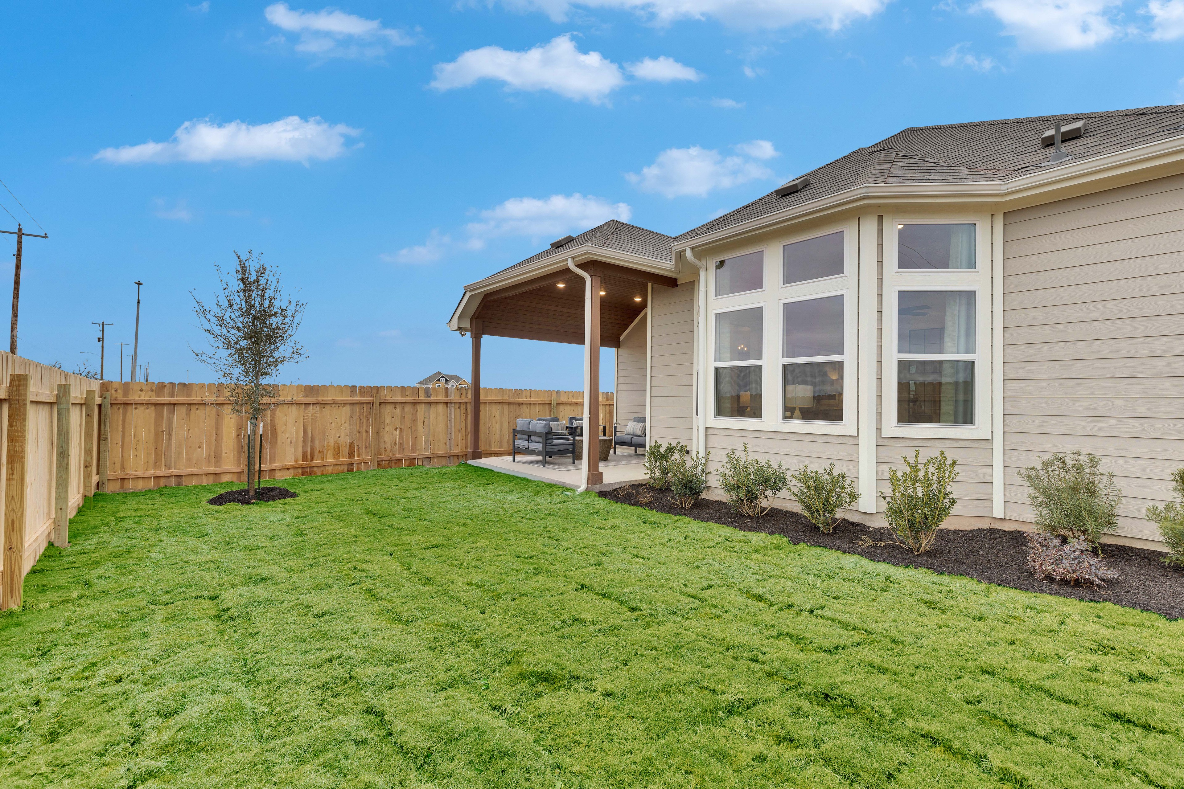 Modern Home with Patio in Spring Creek Community Modern single-story home with large windows and covered patio in Spring Creek community.