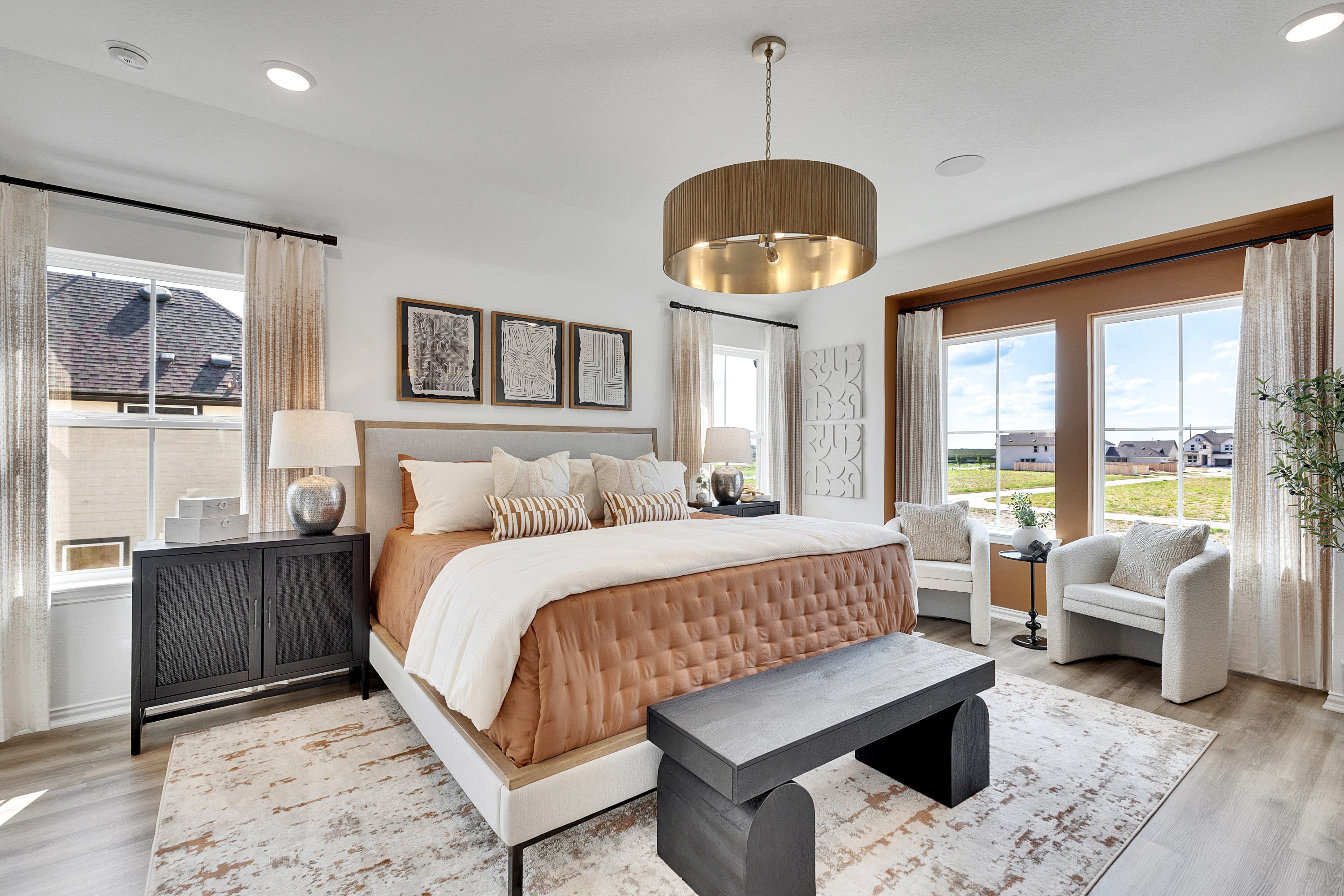 Luxurious Bedroom Interior in Spring Creek Residence Elegant bedroom with modern decor, large windows, plush bedding, and chic chandelier in Spring Creek community.