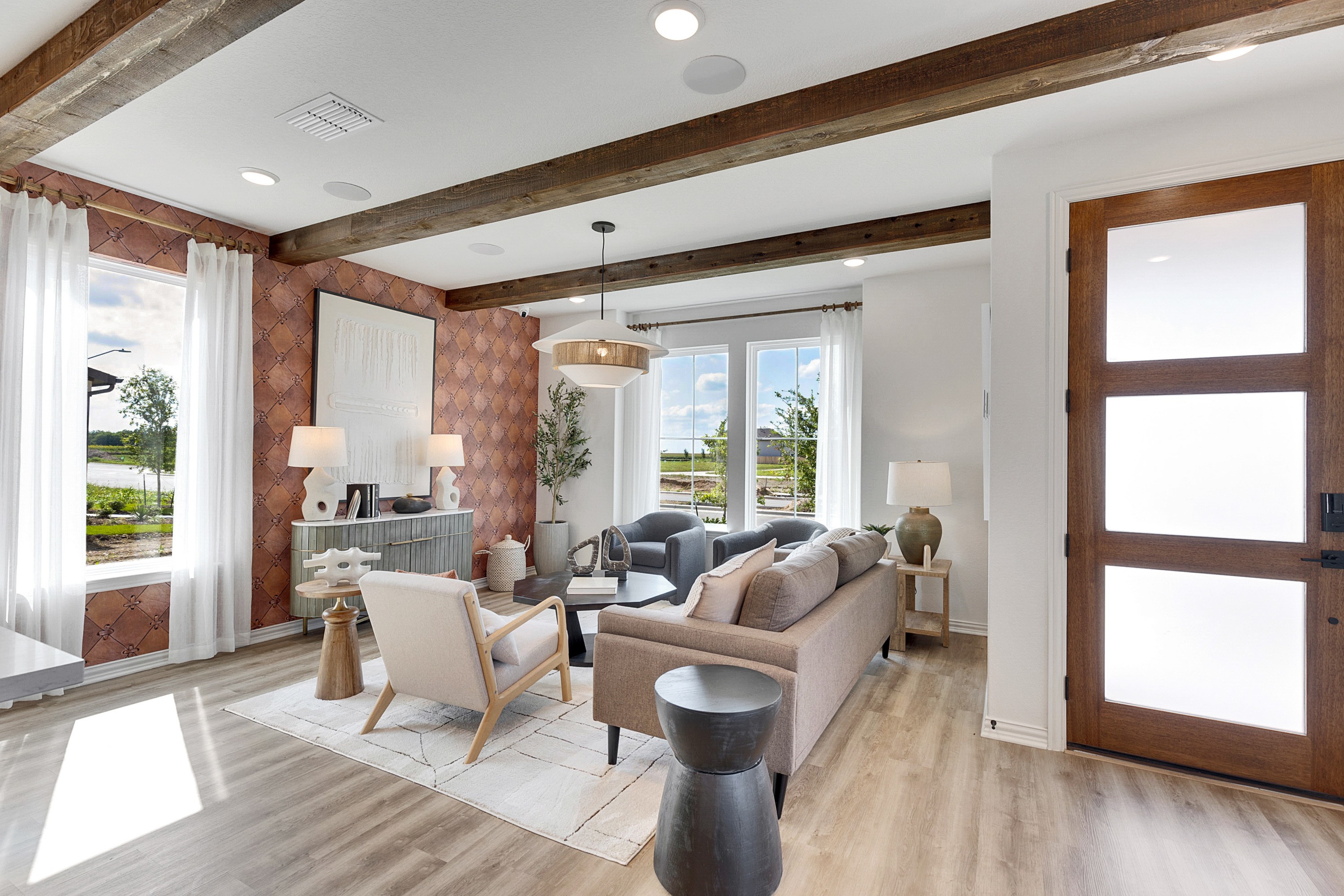 Elegant Living Room with Rustic Beams in Spring Creek Community Elegant living room with rustic beams, large windows, luxury decor in Spring Creek community. SEO keywords.