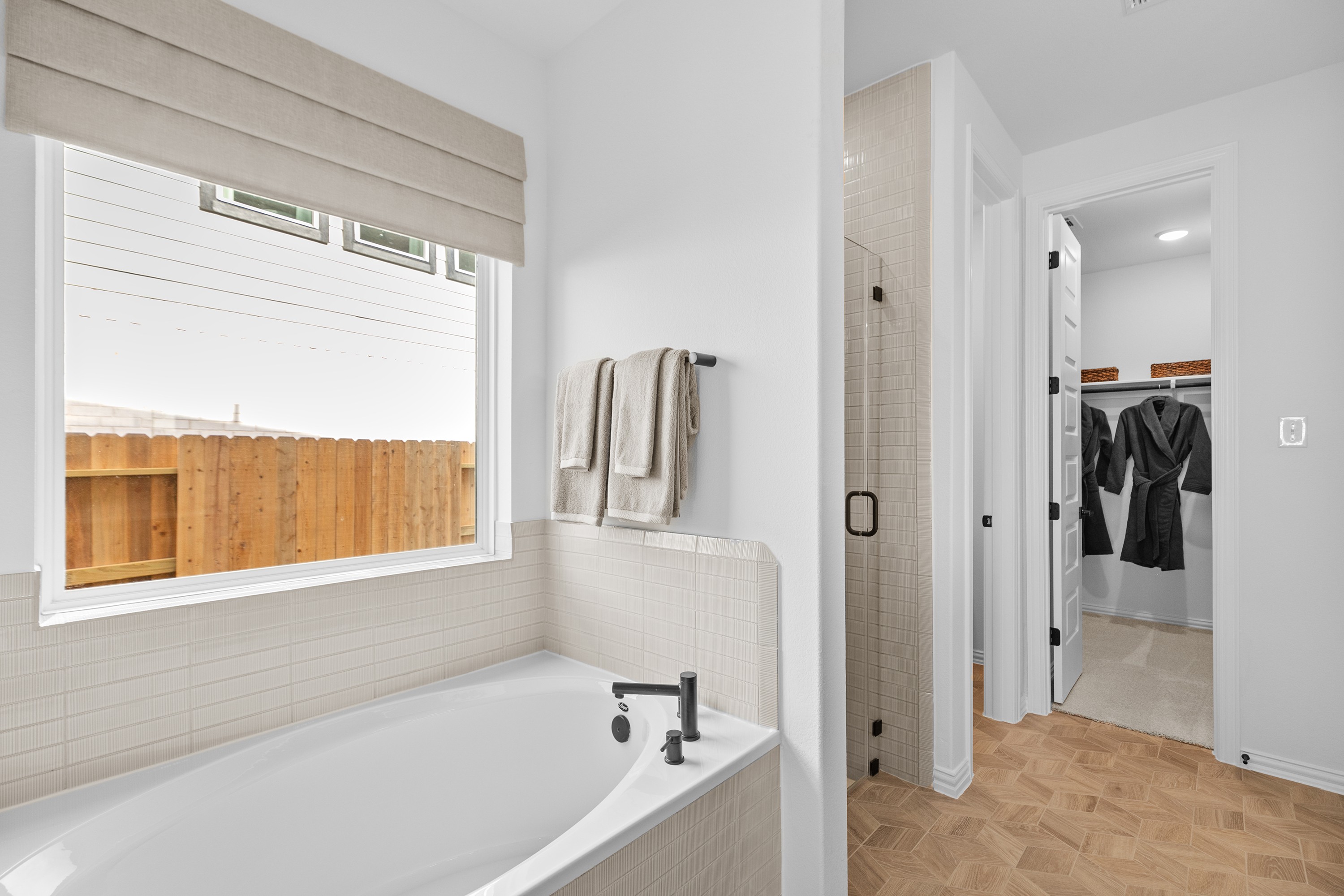 Elegant Bathroom with Tub and Shower in River Ranch Community Luxurious bathroom with modern tub, glass shower, and spacious closet in River Ranch community.