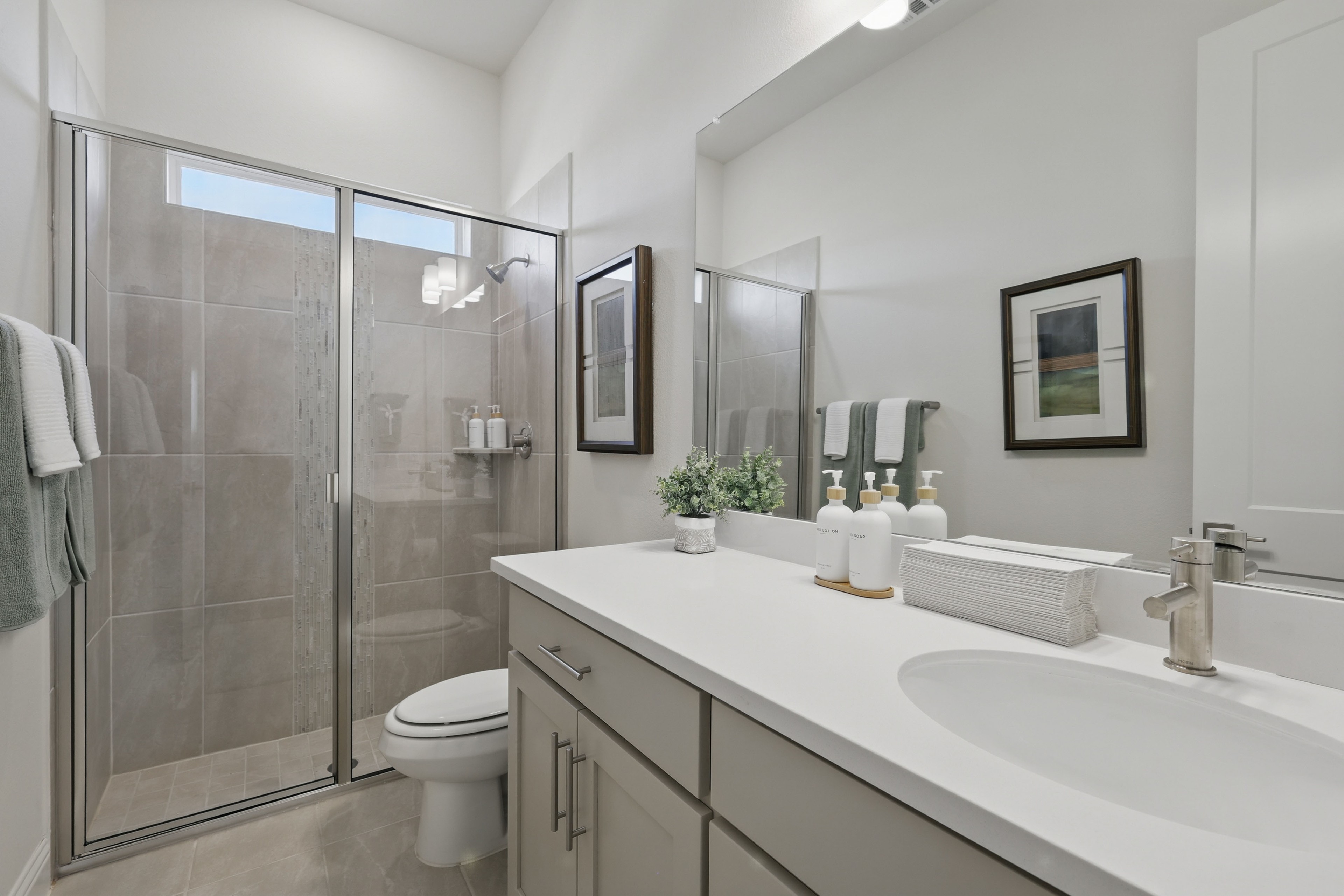 Elegant Bathroom Design in Rio Vista at Kelly Ranch Modern bathroom in Rio Vista at Kelly Ranch, features white vanity, glass shower, minimalist decor.