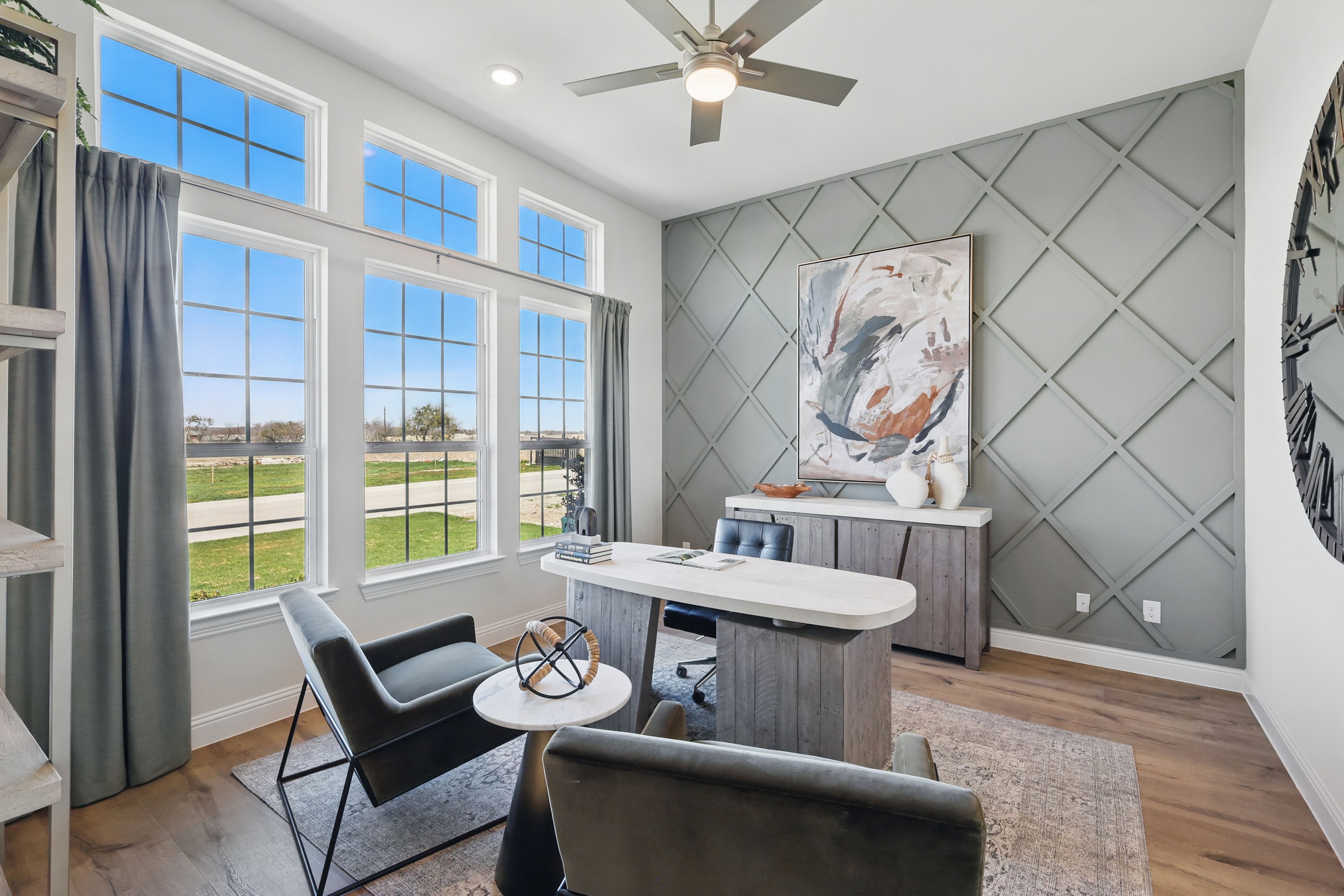 Modern Home Office with Large Windows in Rio Vista at Kelly Ranch Home office with large windows, diamond-patterned accent wall, modern furniture, Rio Vista at Kelly Ranch.