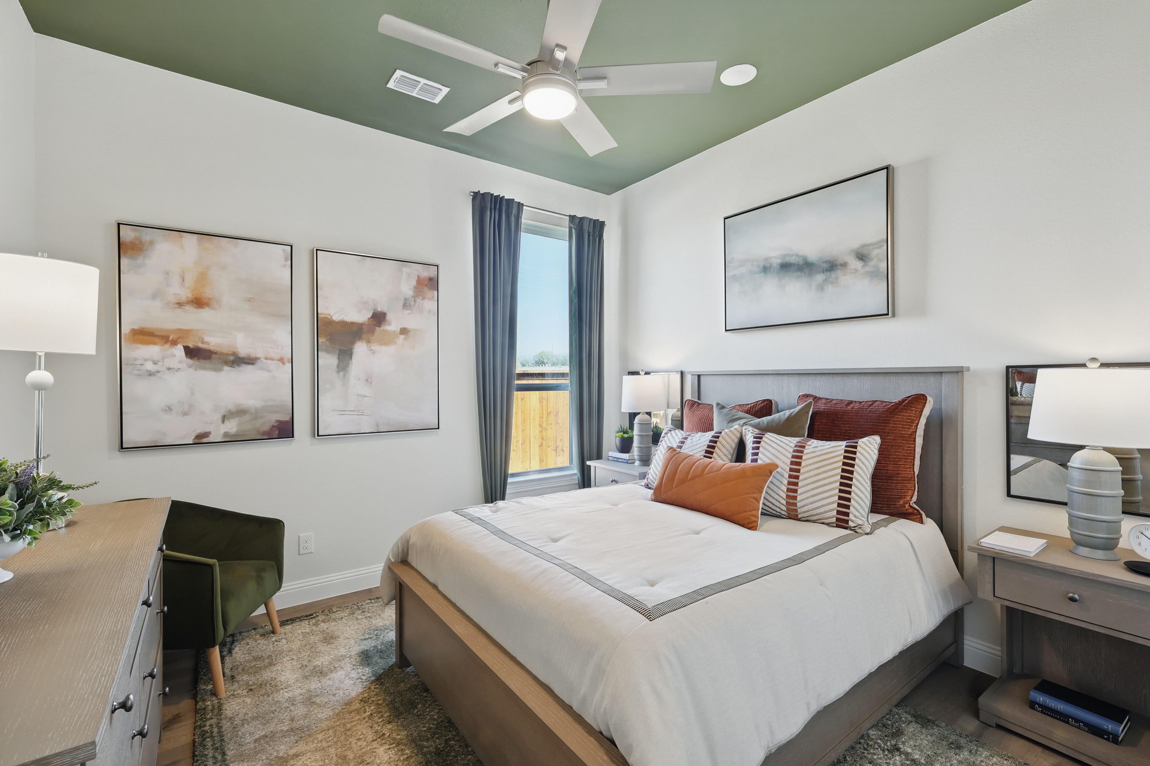 Elegant Bedroom Design in Rio Vista Kelly Ranch Stylish bedroom with modern decor, green ceiling, abstract art, in Rio Vista at Kelly Ranch.