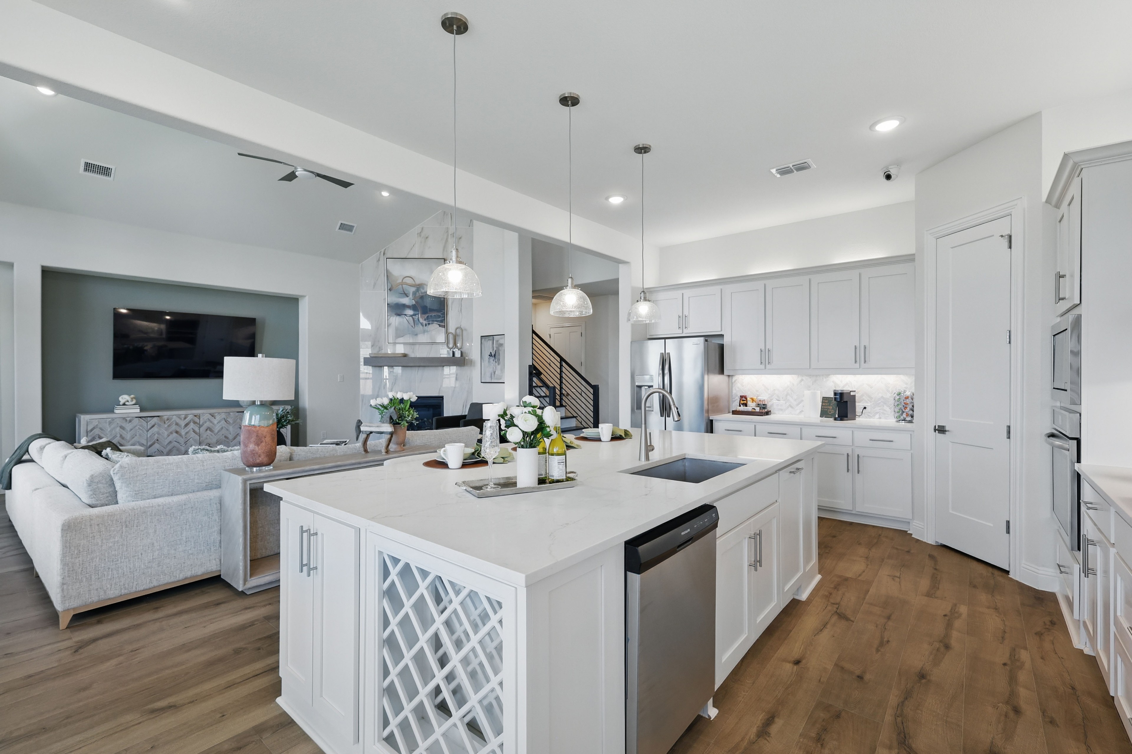 Luxurious Kitchen in Rio Vista at Kelly Ranch with Marble Island Modern kitchen and living area with white cabinets, marble island, stainless appliances in Rio Vista at Kelly Ranch.