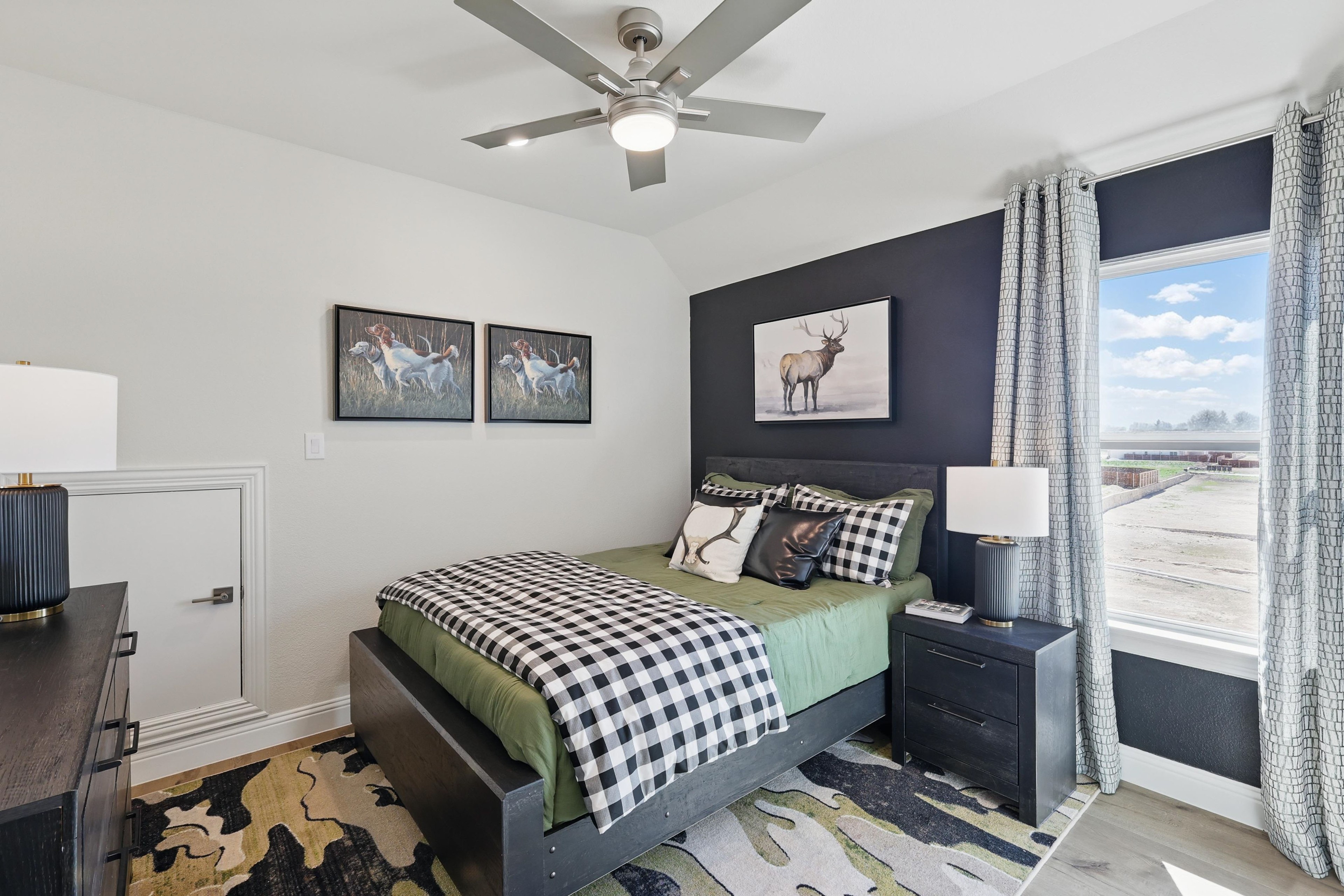 Luxurious Bedroom with Scenic View at Rio Vista, Kelly Ranch Bedroom with black accent wall, plaid bedding, animal artwork, large window view at Kelly Ranch, Rio Vista.