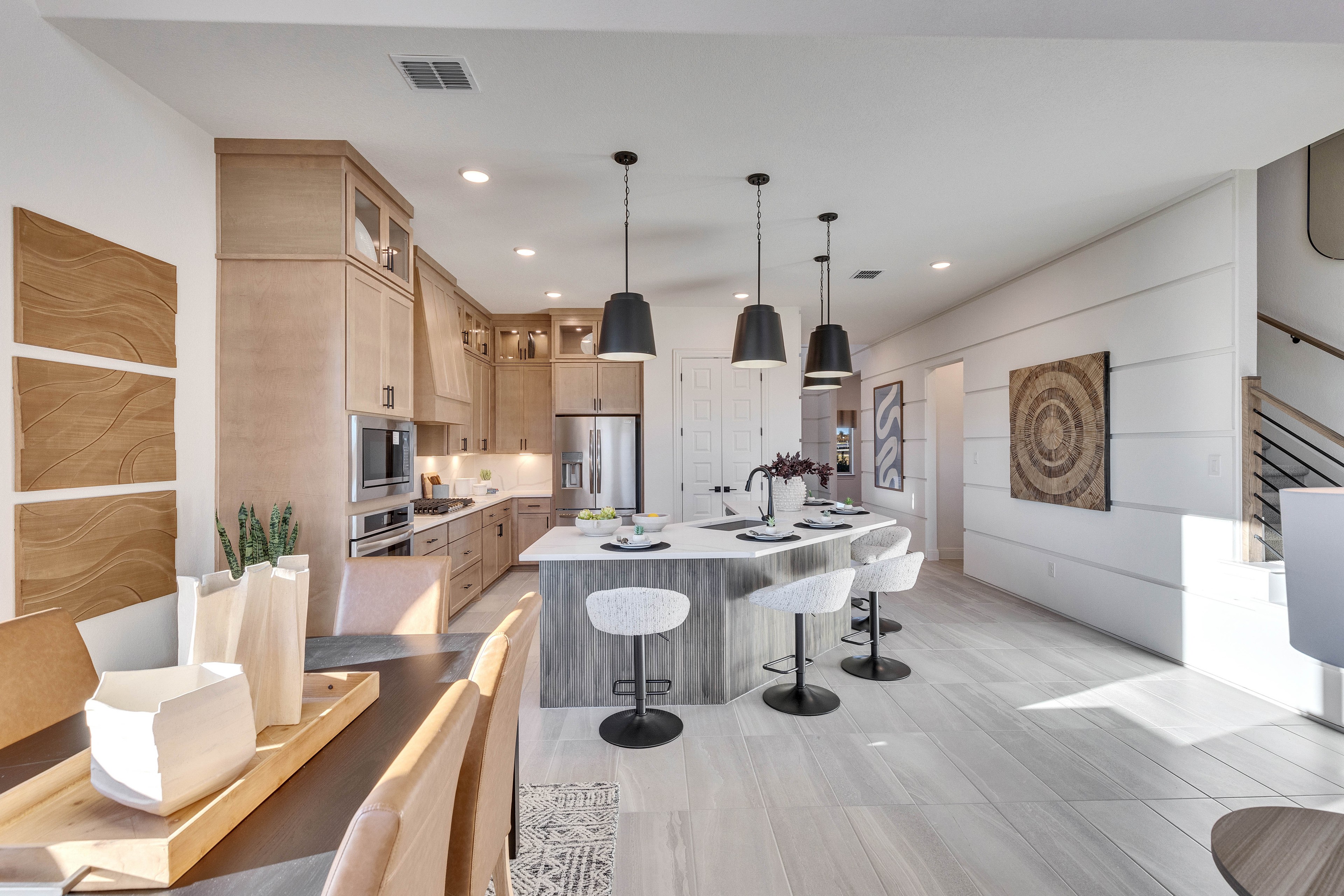 Modern Kitchen Design with Island and Dining Area, Creeks Crossing Modern kitchen with light wood cabinets, island, dining table, and stylish pendant lights, Creeks Crossing.