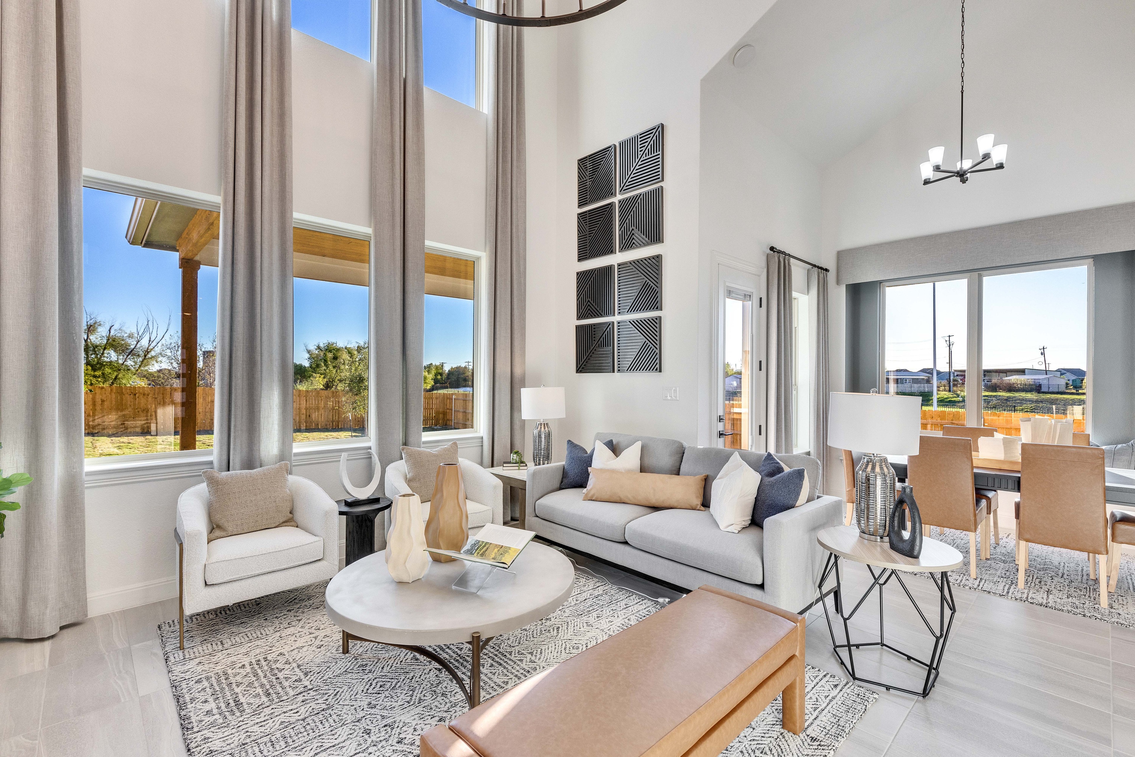 Modern Living Room with High Ceilings in Creeks Crossing Community Elegant modern living room, high ceilings, large windows, stylish decor, Creeks Crossing community.