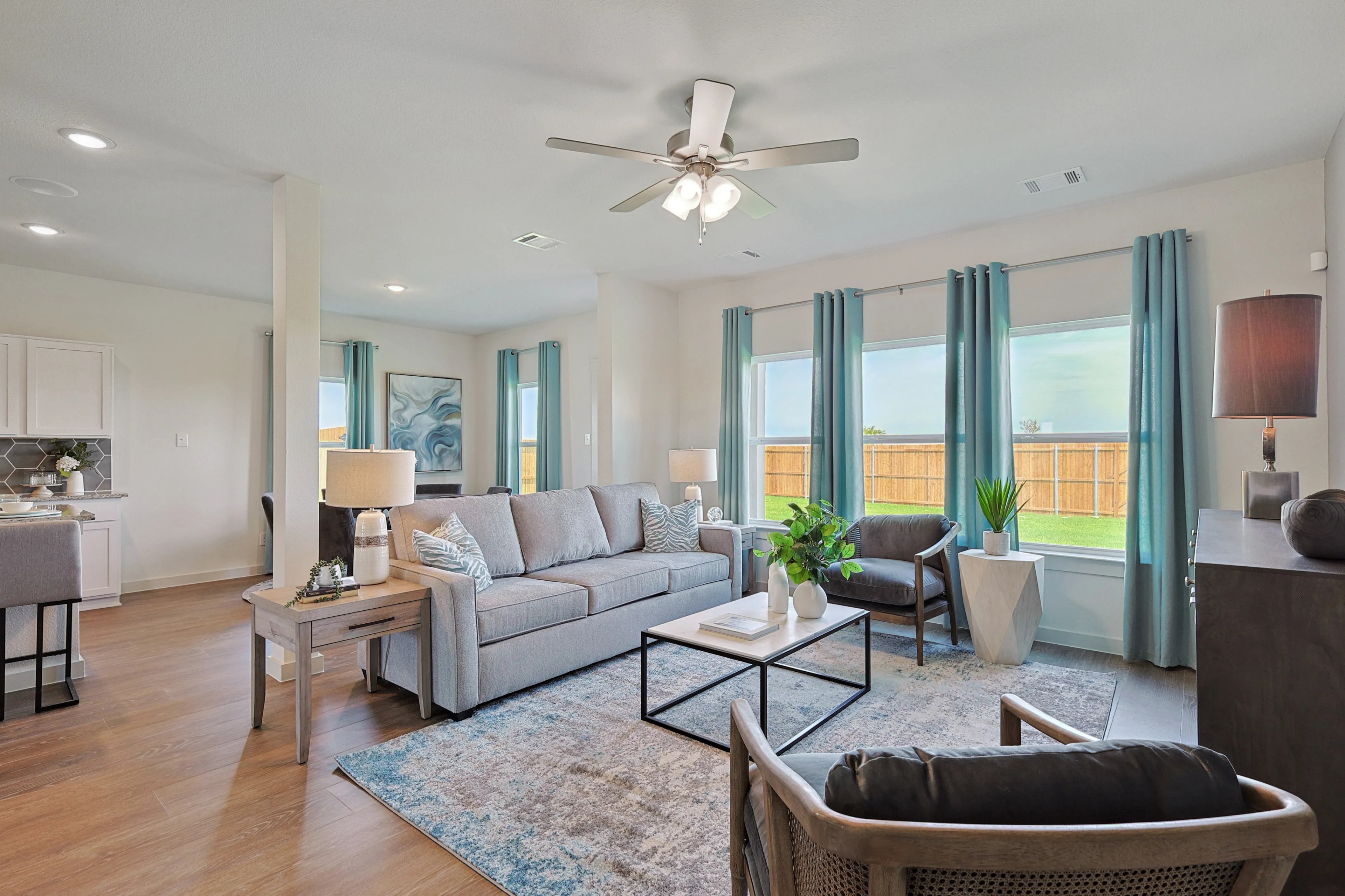 Elegant Living Room, Modern Design, Patriot Estates Modern living room with large windows, light wood flooring, cozy seating, Patriot Estates community.