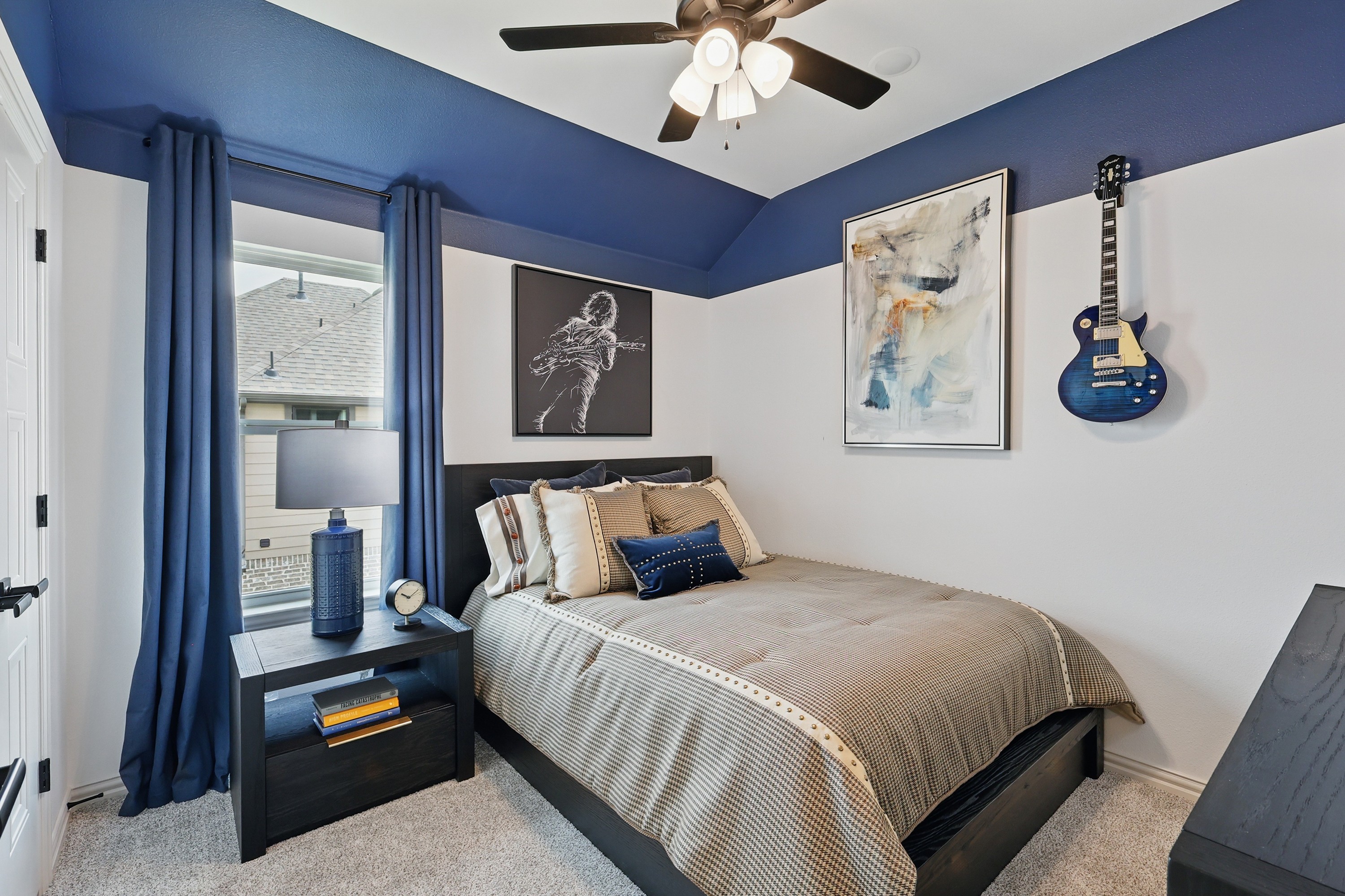 Elegant Bedroom with Artistic Flair in Westridge Community Cozy bedroom with blue accents, stylish wall art, and decorative guitar in Westridge community.