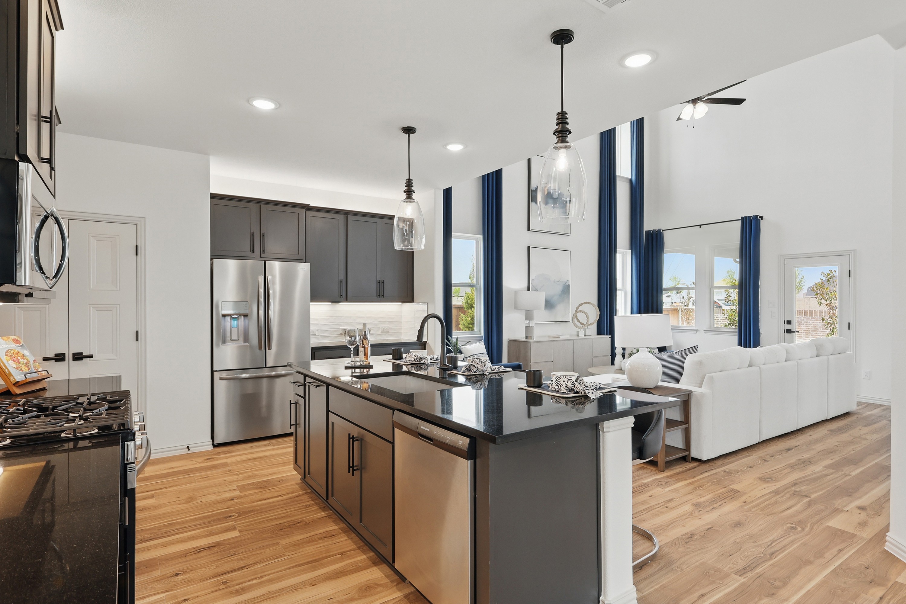 Modern Kitchen and Living Area in Westridge Community Home Modern kitchen with black island, stainless-steel appliances, open living area, Westridge community.