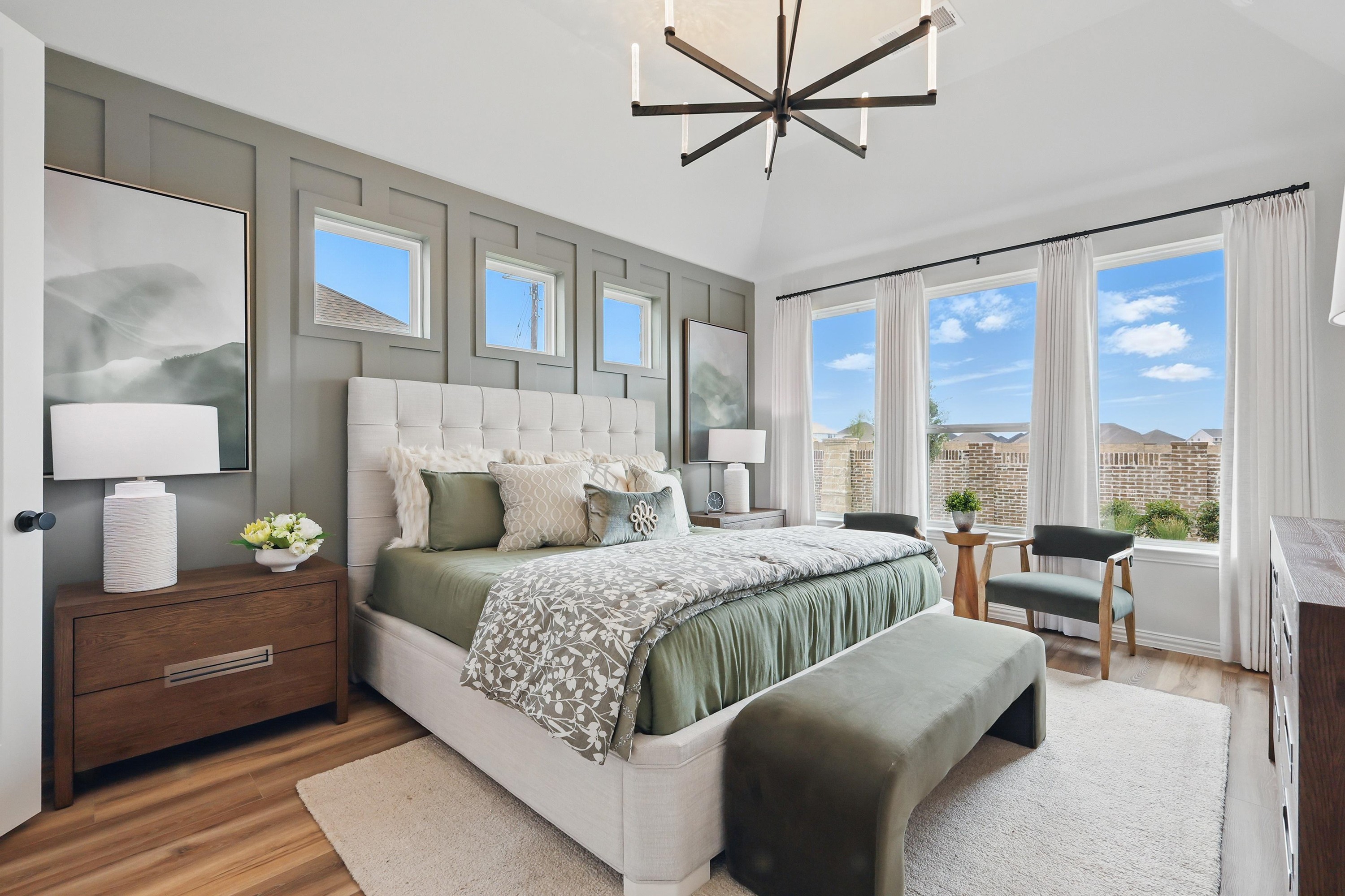 Luxury Bedroom with Modern Design in Westridge Community, Texas Elegant bedroom with green accents, statement light fixture, and large windows in Westridge community, Texas.