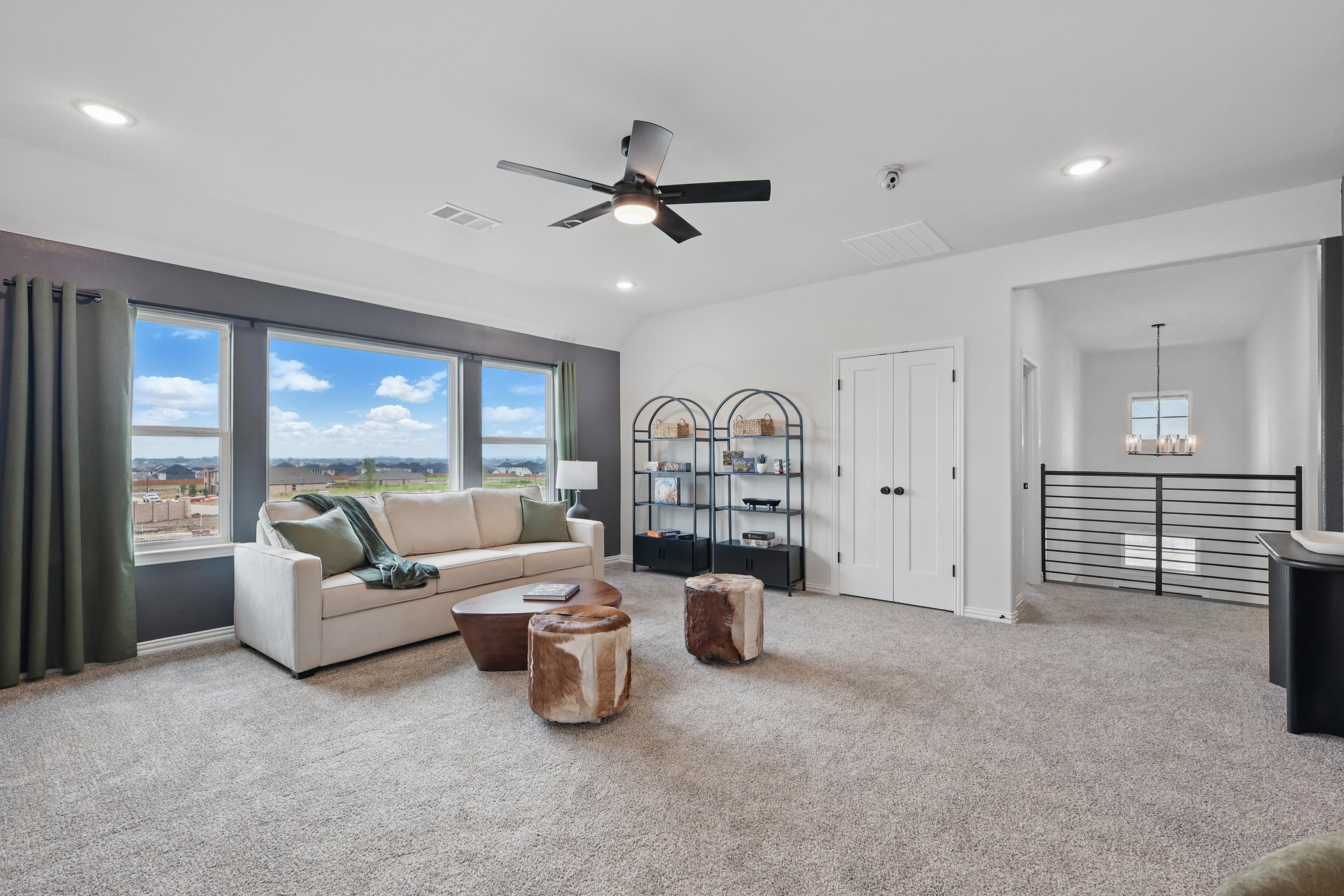 Elegant Living Room with Scenic Views in Westridge Community Spacious living room with beige sofa, large windows, modern fan, and views, Westridge community.