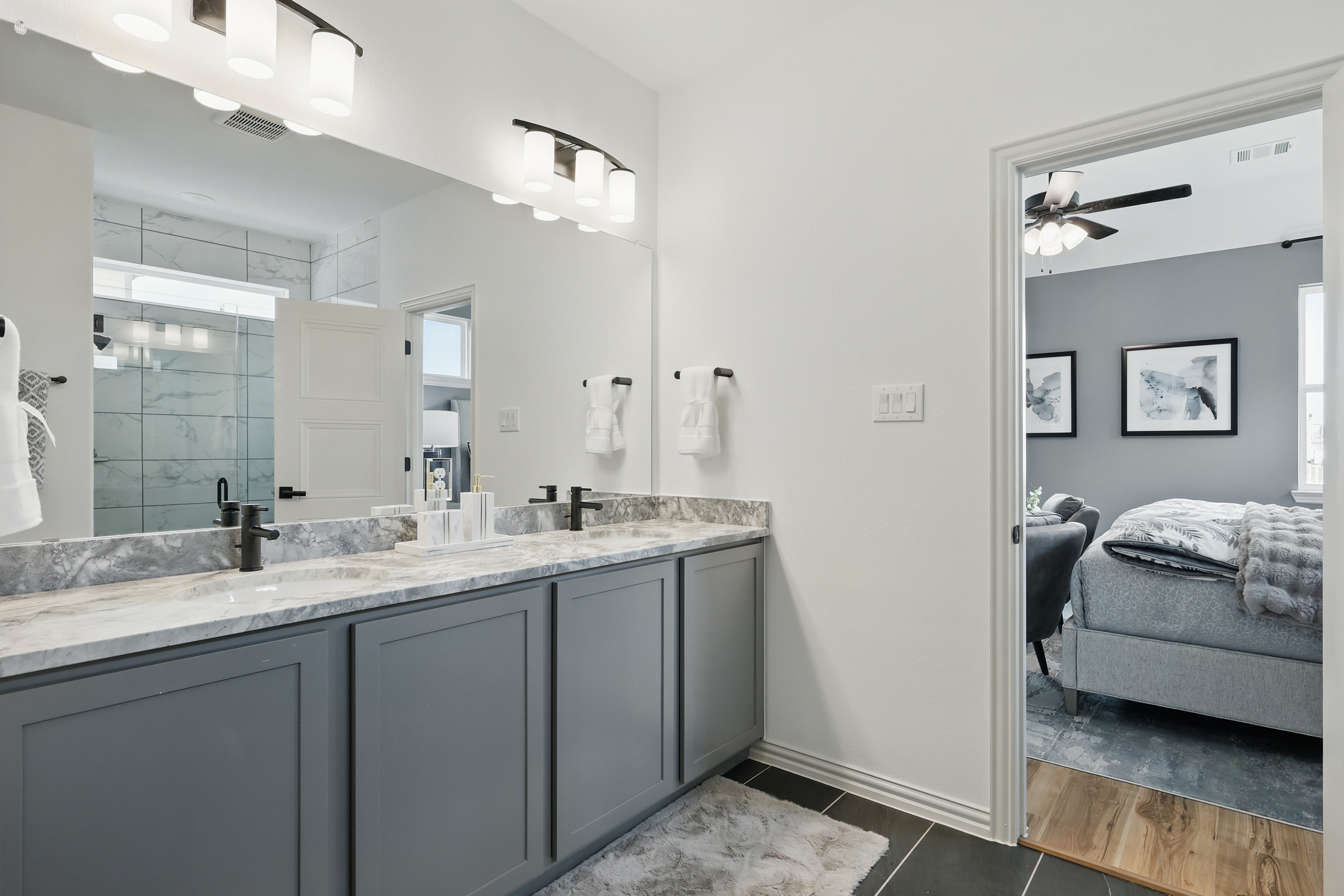 Elegant Westridge Bathroom with Marble Vanity and Black Fixtures Modern Westridge bathroom with marble double vanity, sleek black fixtures, and spacious shower. Bedroom visible through door.