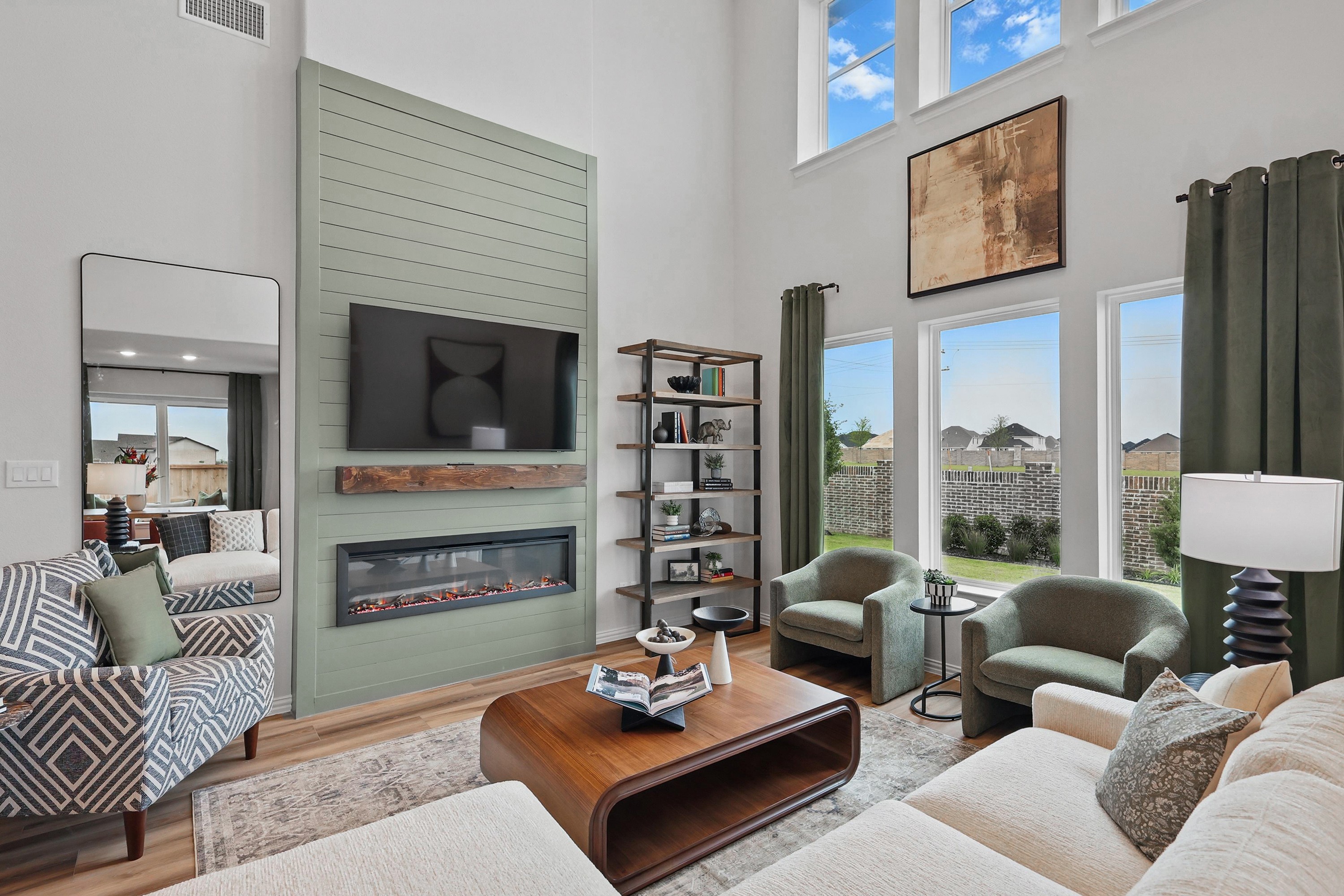 Spacious Westridge Living Room with High Ceilings and Fireplace Modern living room, high ceilings, large windows, green shiplap fireplace, Westridge. Cozy seating arrangement.