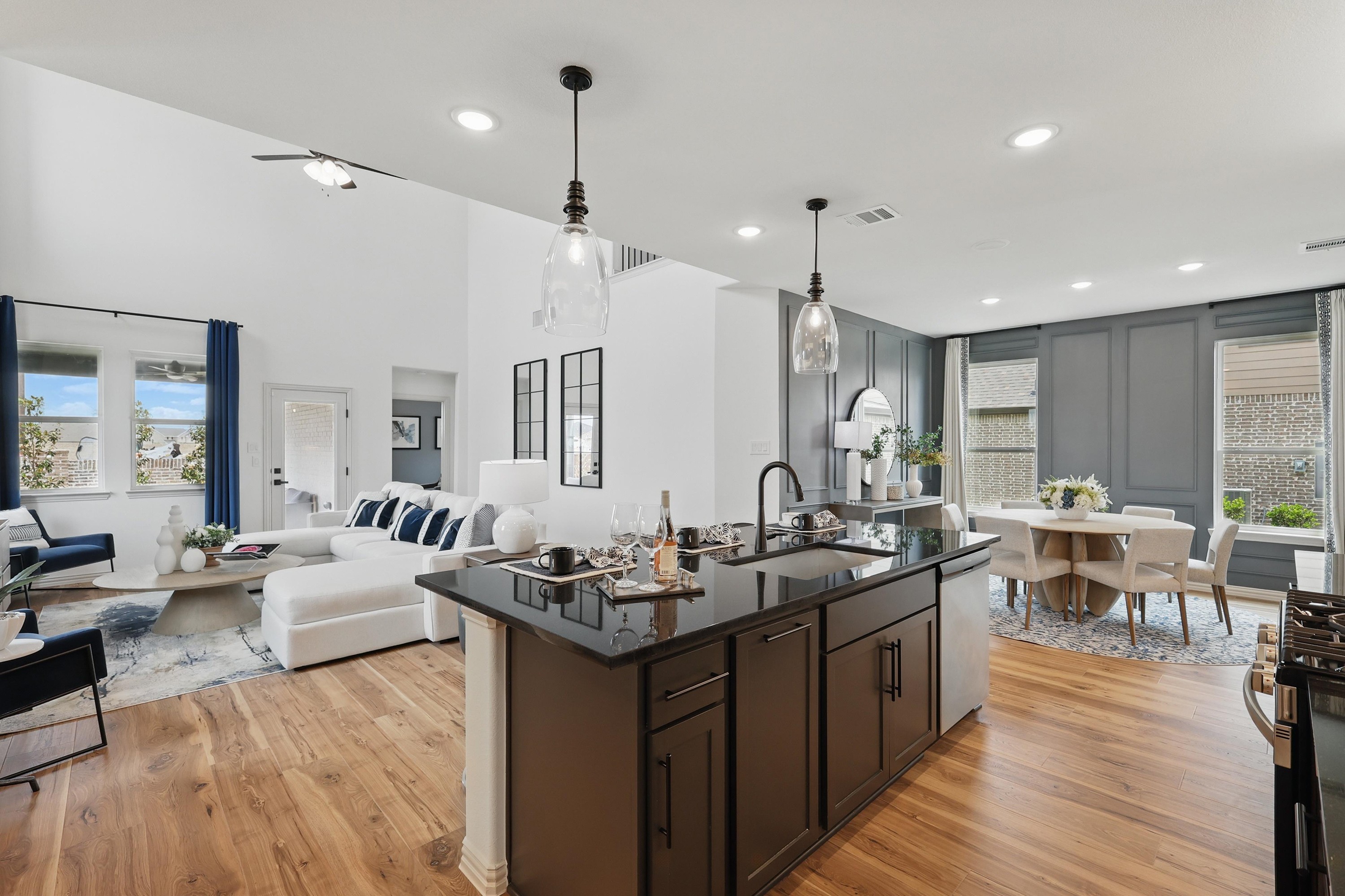 Open-Concept Living Room and Kitchen, Westridge Community Modern open-concept living room and kitchen with high ceilings, wood floors, and elegant furnishings in Westridge community.