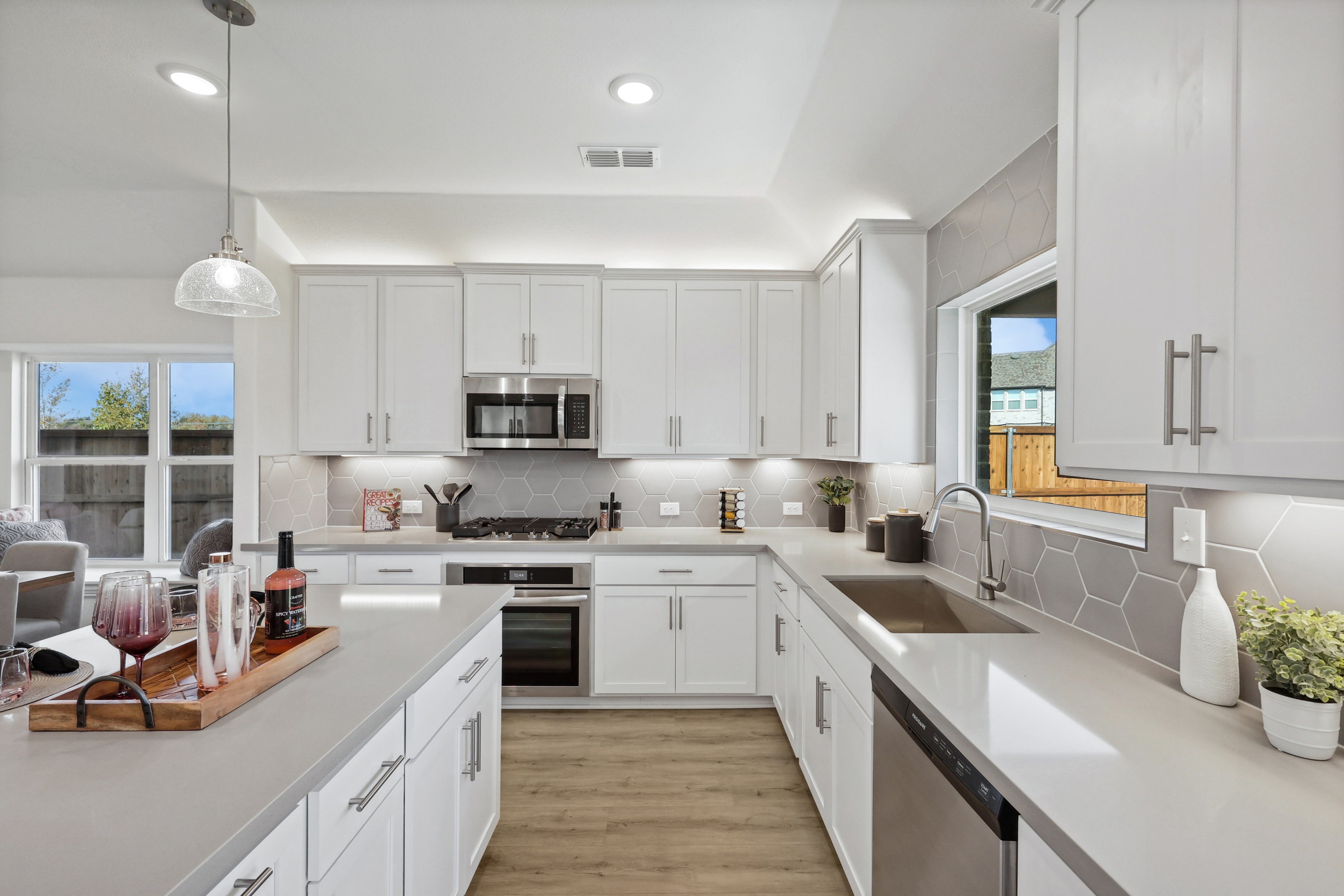 Modern Kitchen with White Cabinets in Bel Air Village Community Modern kitchen with white cabinets, hexagonal backsplash, stainless appliances, located in Bel Air Village community.