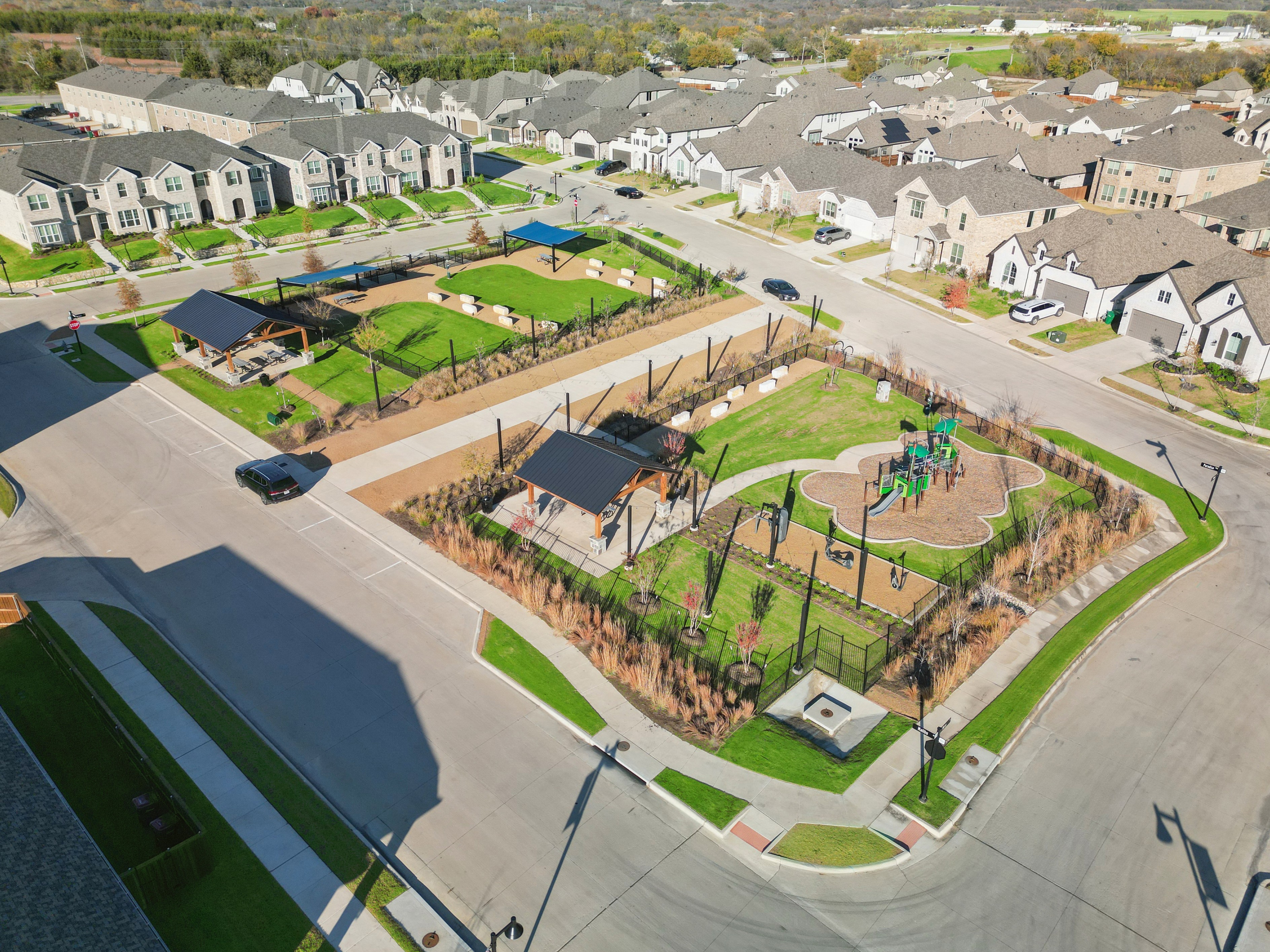 Aerial View of Bel Air Village Community Homes and Parks Aerial view of Bel Air Village community with modern homes, lush parks, and a playground in a well-planned urban setting.