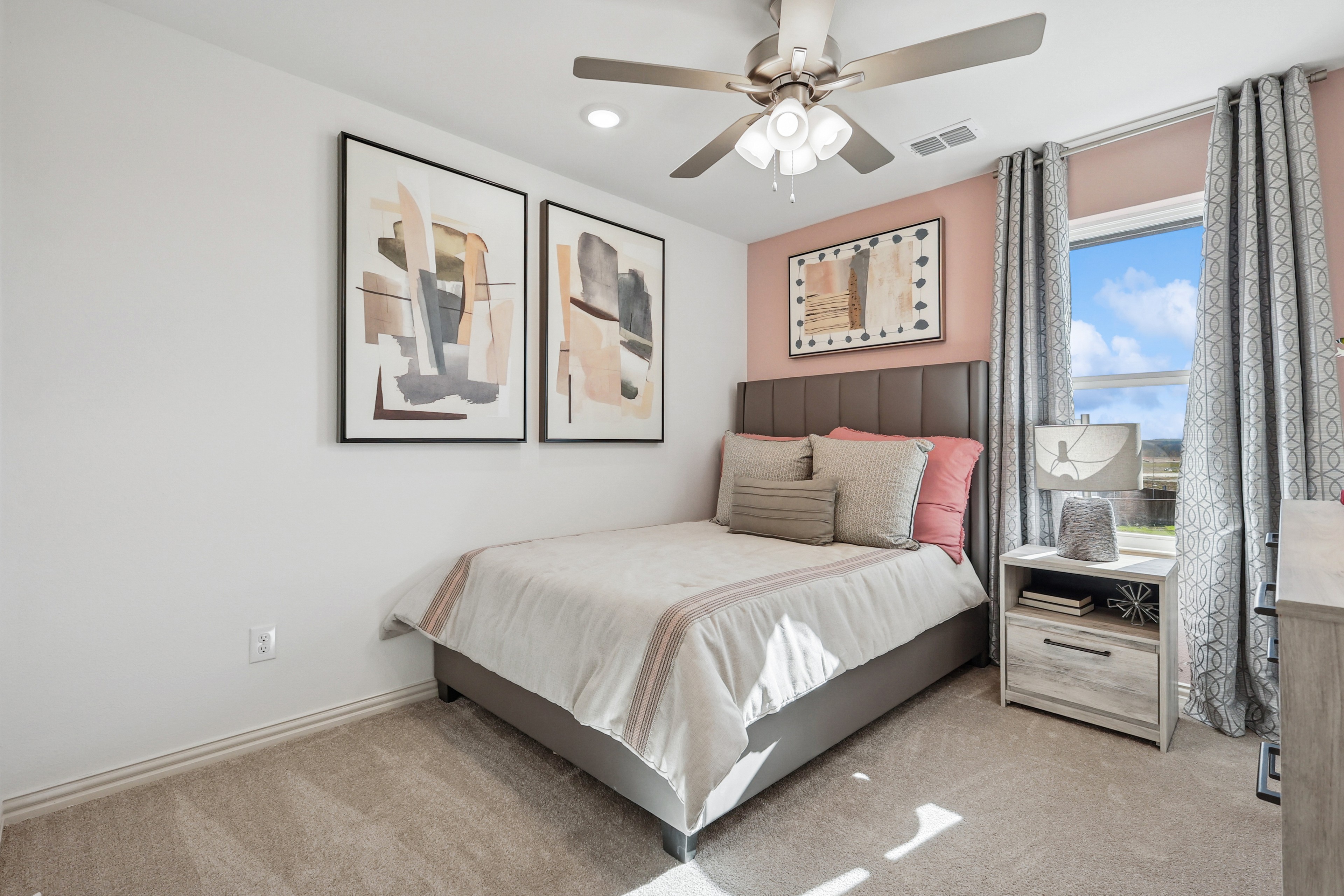 Stylish Bedroom with Art in Bel Air Village Residence Elegant bedroom with abstract art, plush bed, modern fan, and window view in Bel Air Village home.