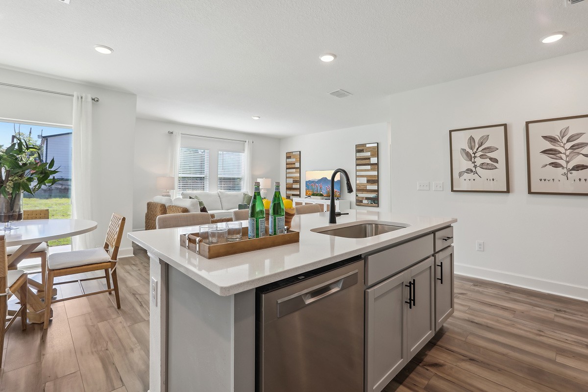Modern Kitchen in Spring Hill with Island and Open Layout Modern Spring Hill kitchen with white island, stainless steel sink, and open layout.