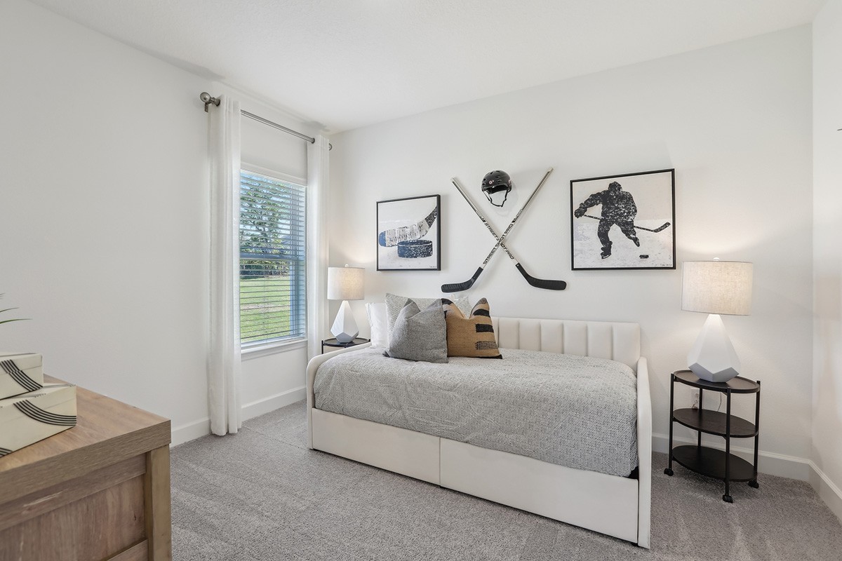 Spring Hill Bedroom with Hockey Decor and Modern Design Modern bedroom in Spring Hill with hockey-themed decor, single bed, and large window.