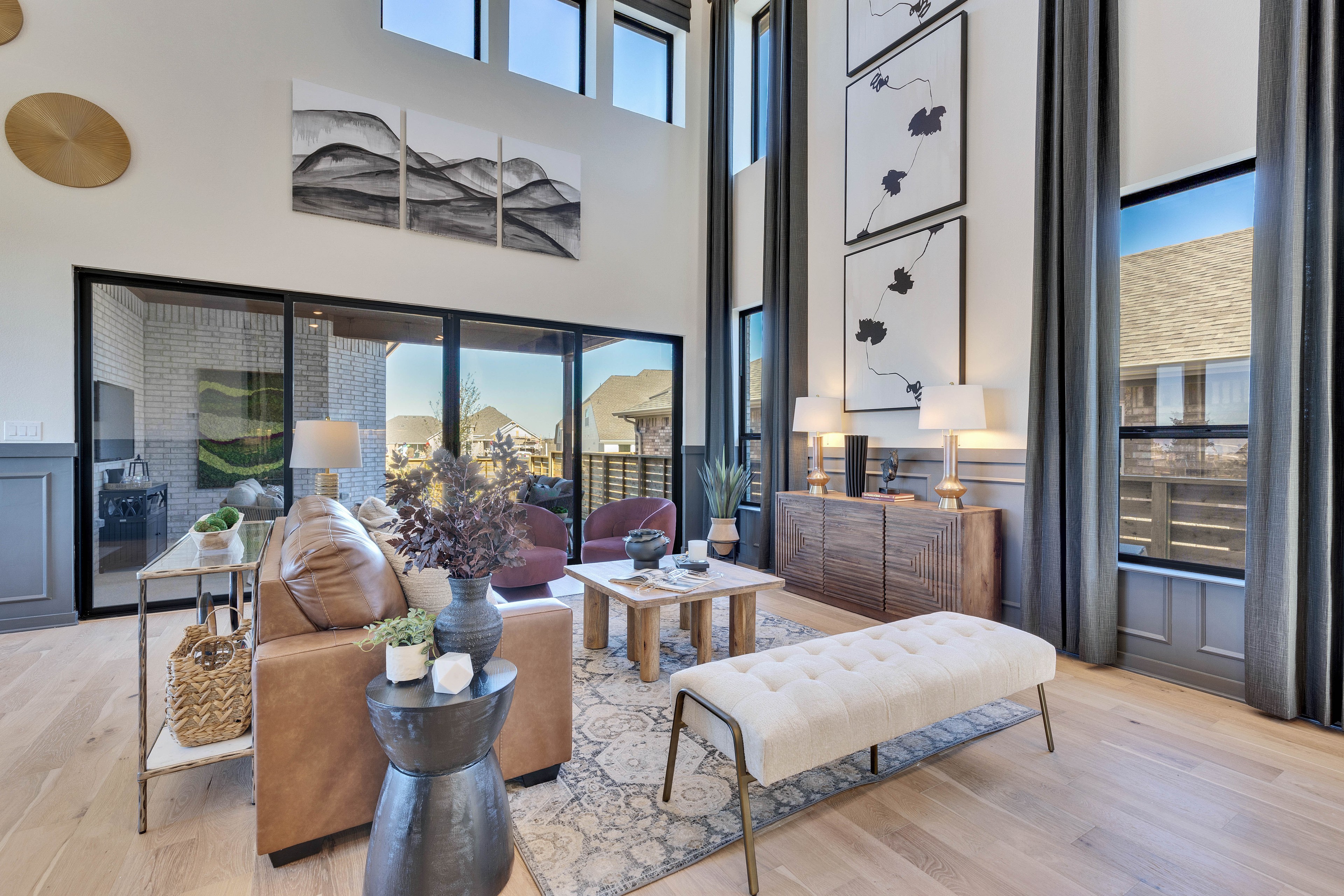 Elegant Modern Living Room with High Ceilings in Flora Community Modern living room, high ceilings, abstract art, large windows, natural light, Flora community.