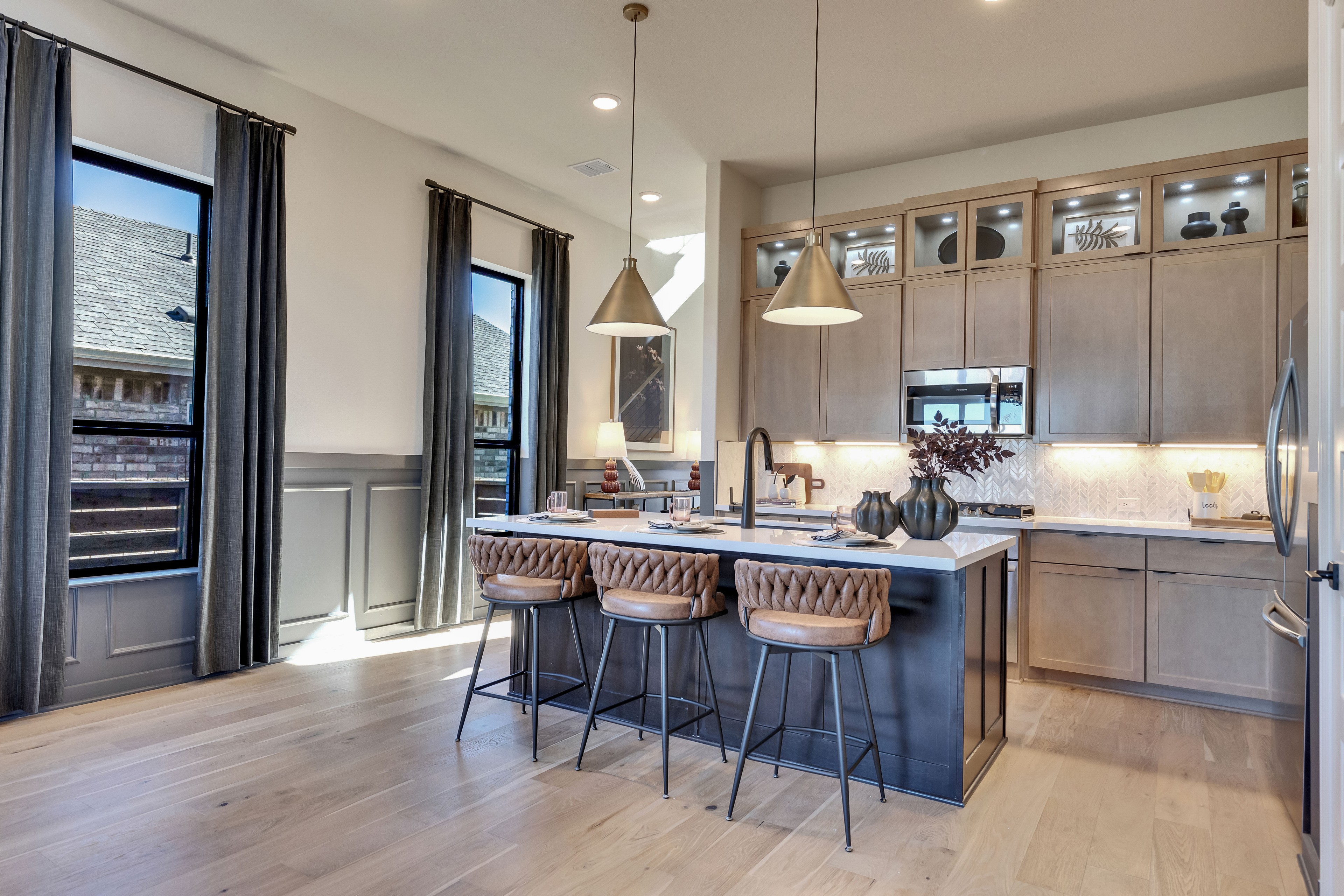 Modern Kitchen with Island in Flora Community Home Modern kitchen with island, pendant lights, and custom cabinets in Flora community home.