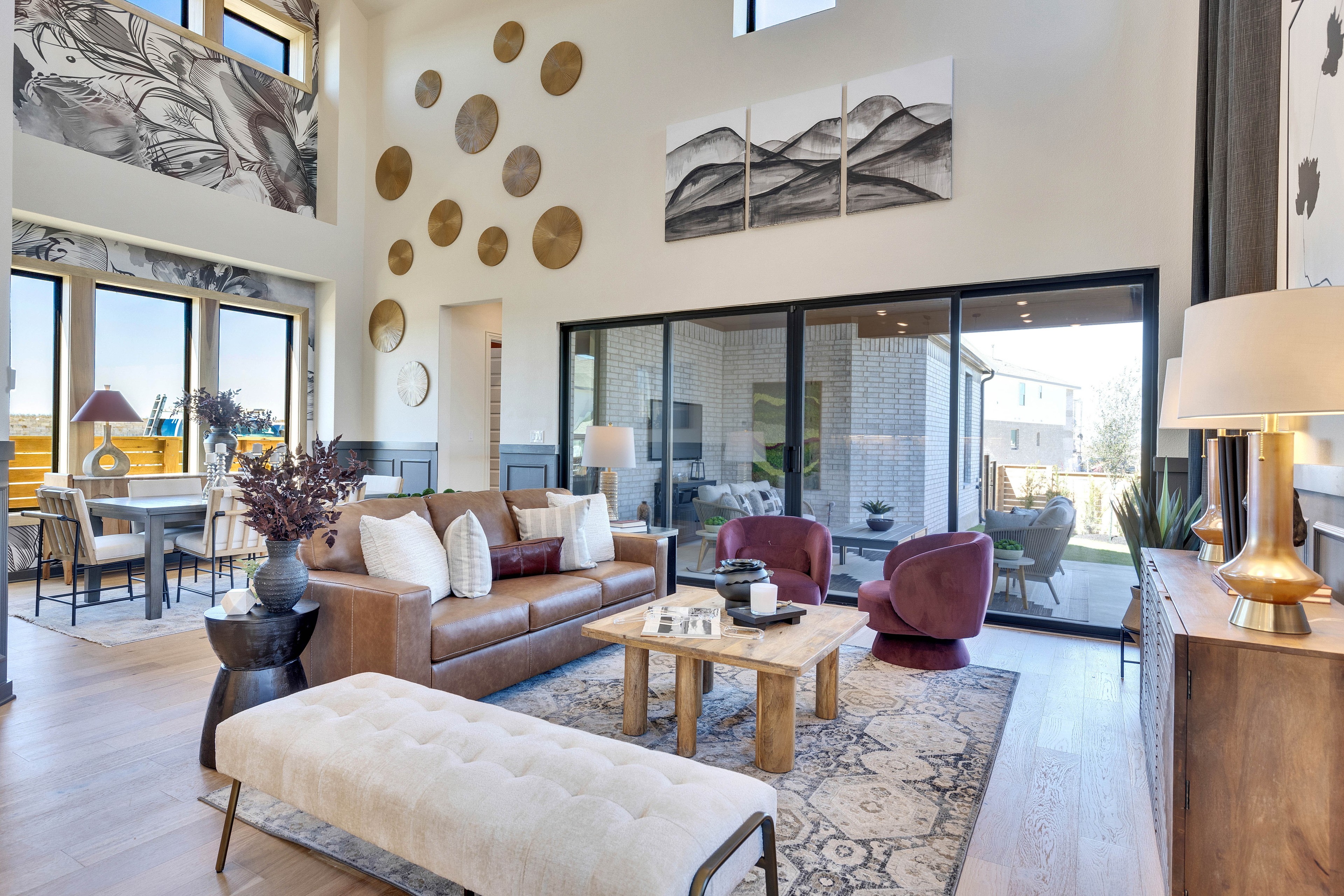 Flora Community Luxury Living Room with Modern Decor Spacious living room in Flora community with high ceilings, modern decor, and large windows offering natural light.