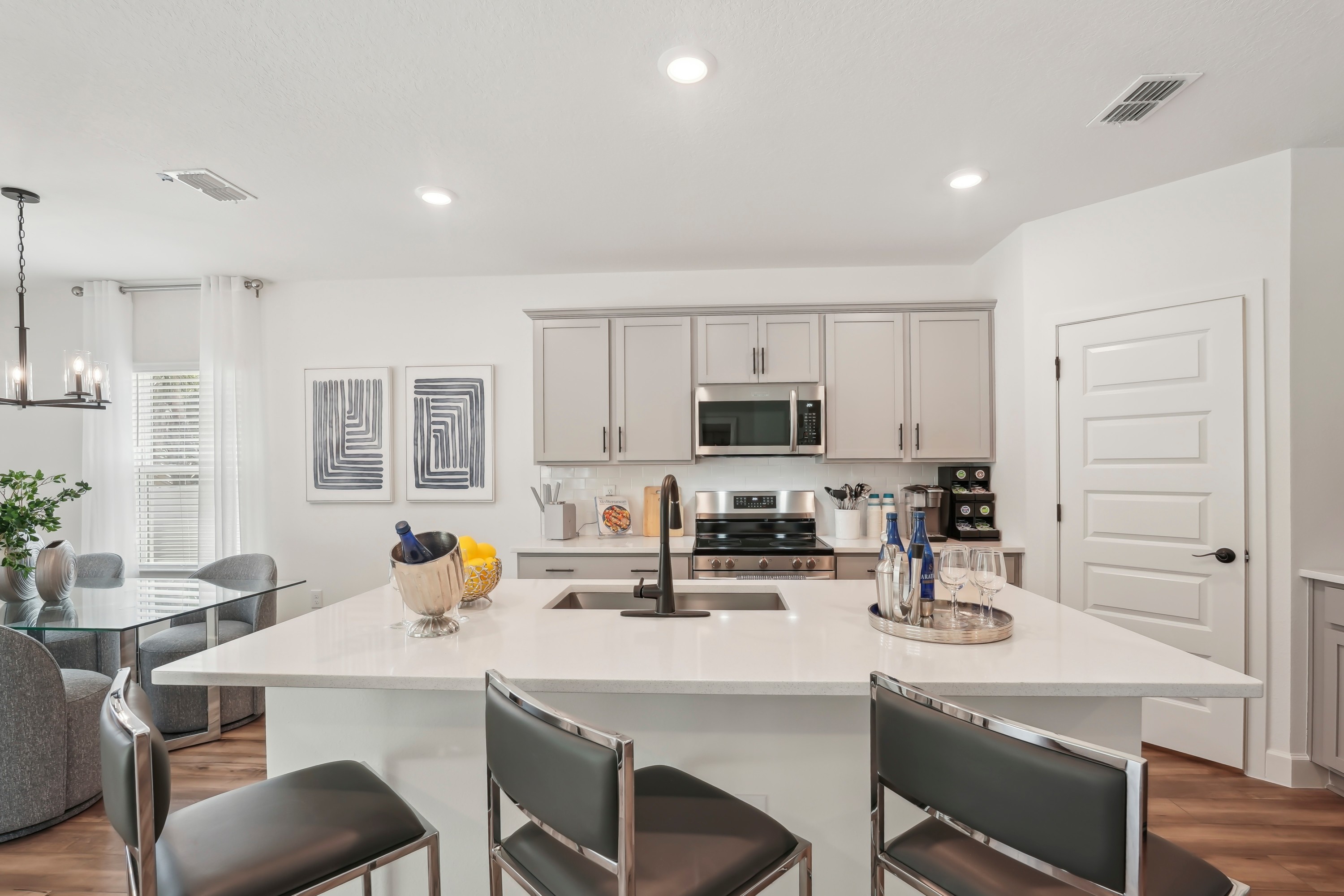 North Port Kitchen with Quartz Island and Modern Appliances Modern North Port kitchen with quartz island, stainless steel appliances, and elegant decor.