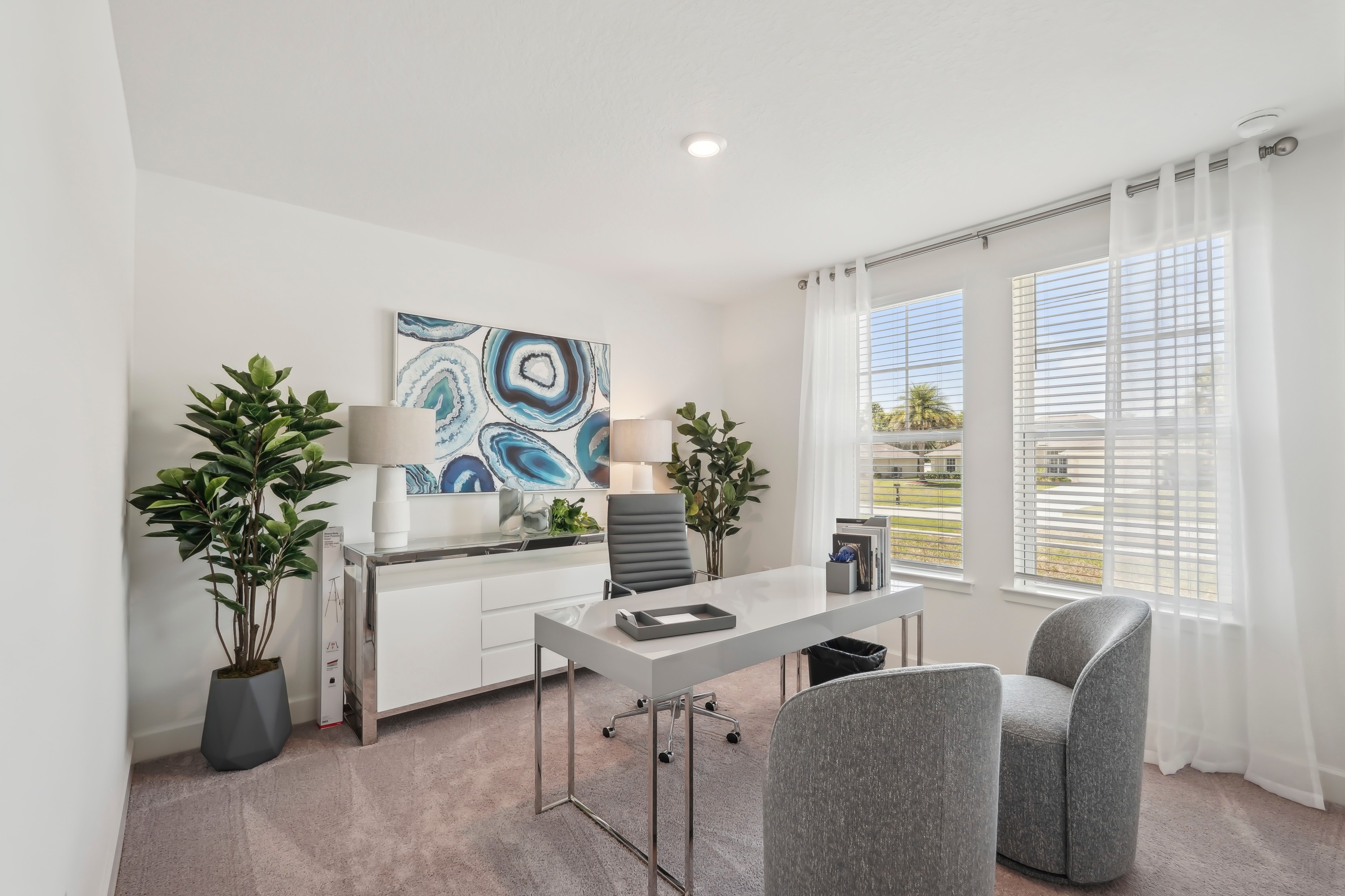 Stylish North Port Home Office with Large Windows and Art Modern home office with large windows, sleek desk, abstract art, in North Port.