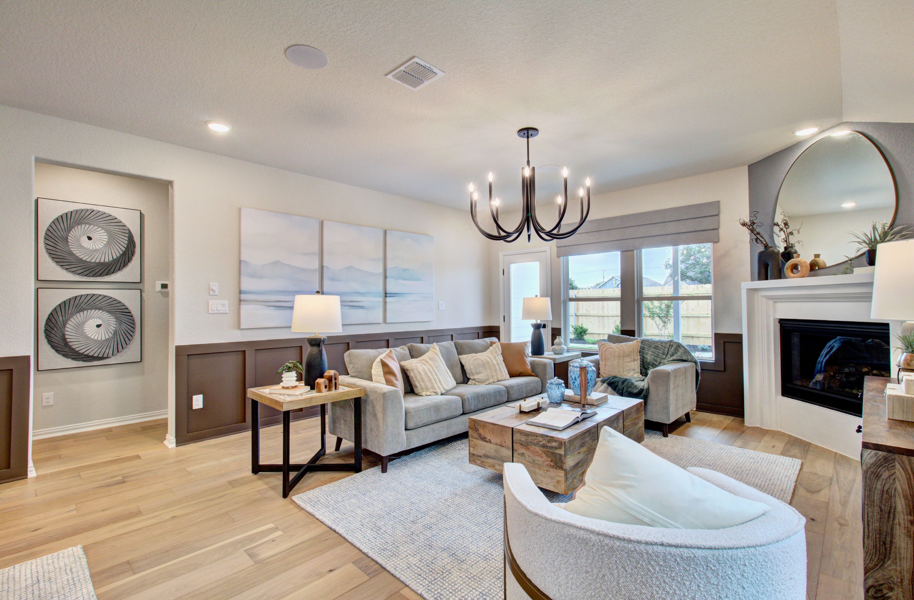 Sunflower Ridge Living Room with Modern Chandelier and Art Elegant living room with modern chandelier, cozy seating, abstract art, Sunflower Ridge.