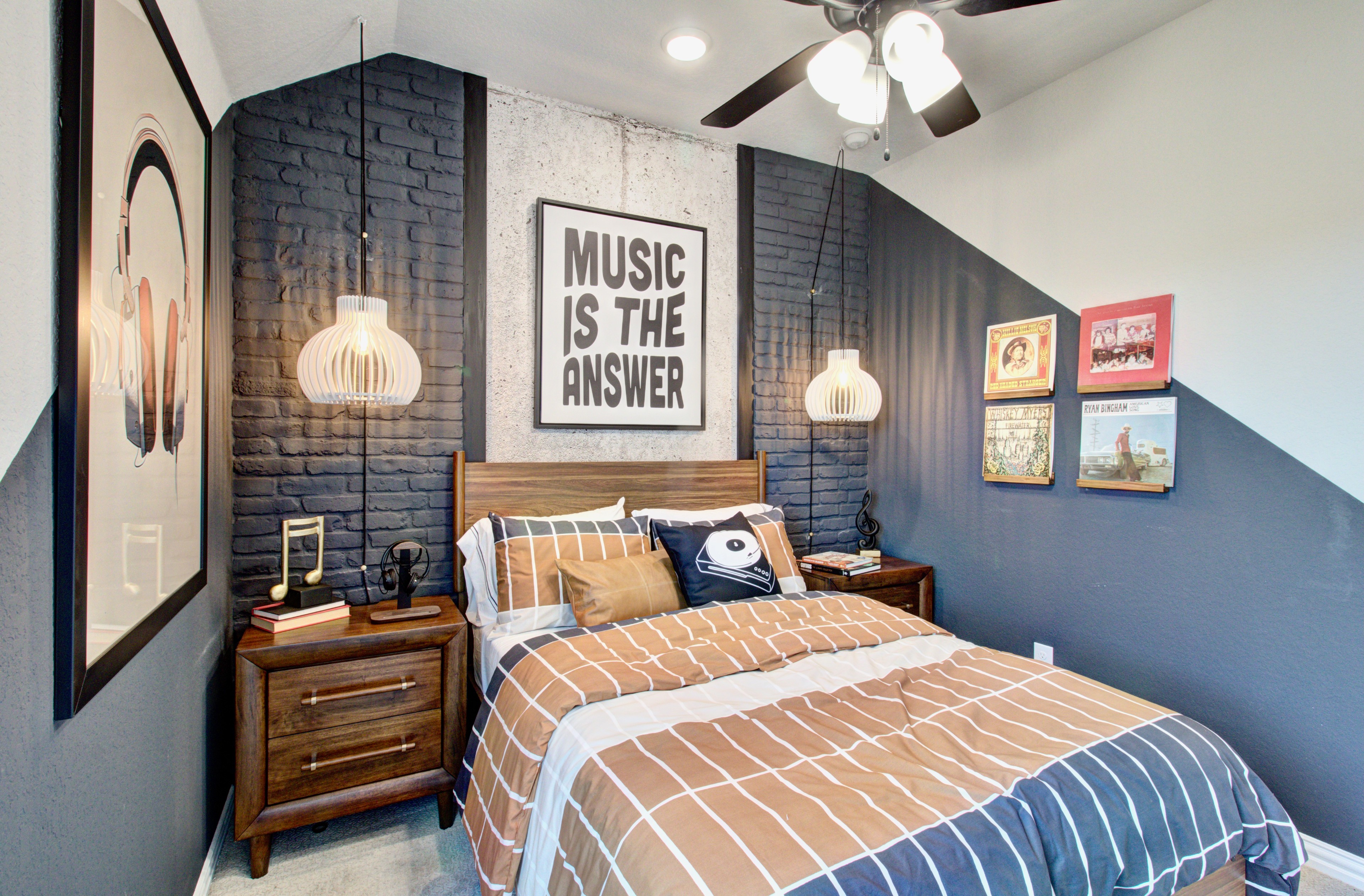 Modern Bedroom with Dark Accent Wall in Sunflower Ridge Bedroom with modern decor, dark accent wall, pendant lights, music-themed art, Sunflower Ridge.