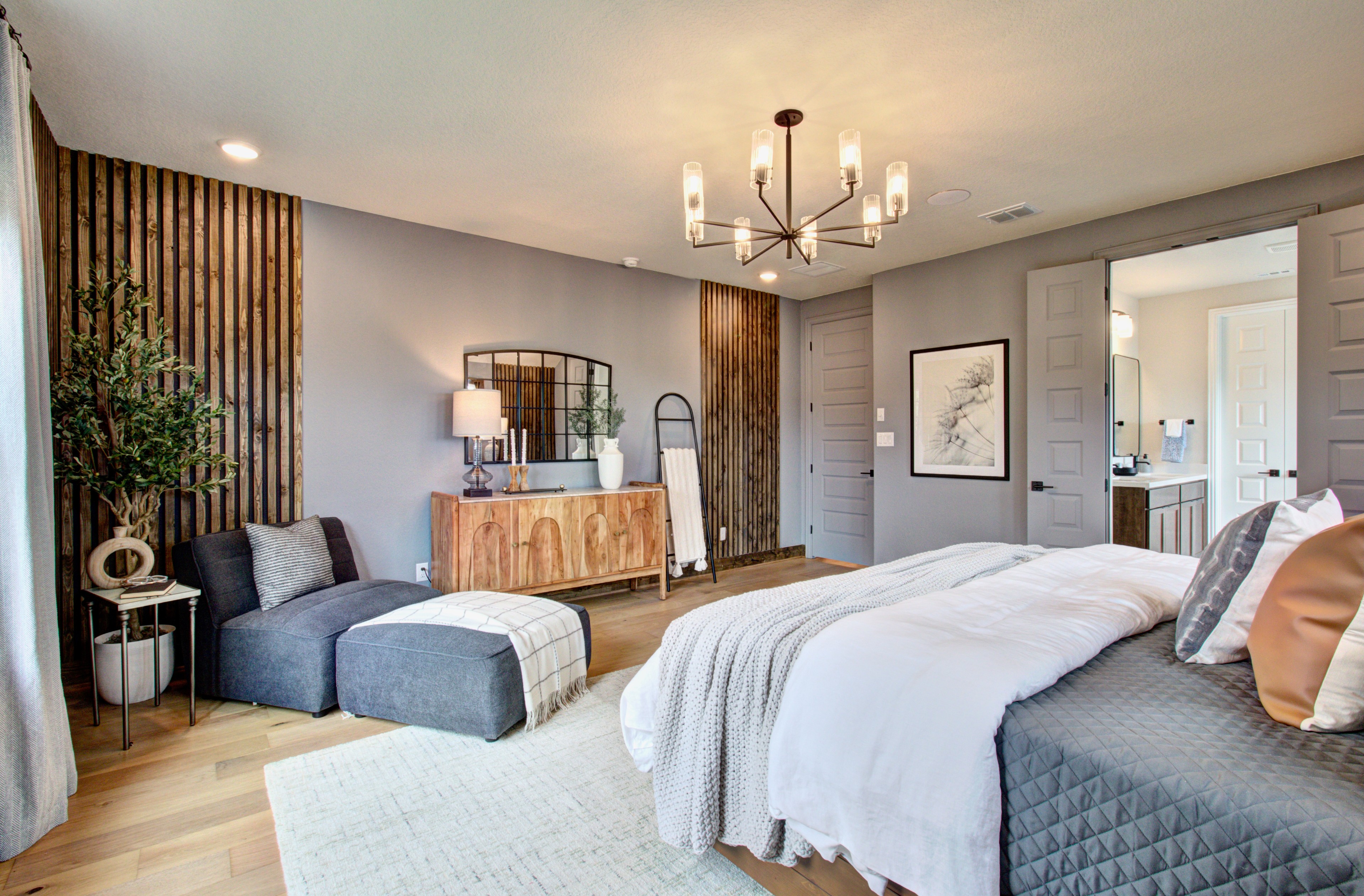 Sunflower Ridge Elegant Bedroom with Modern Decor and Wood Accents Luxurious Sunflower Ridge bedroom with wood accents, modern chandelier, plush seating, and elegant decor.