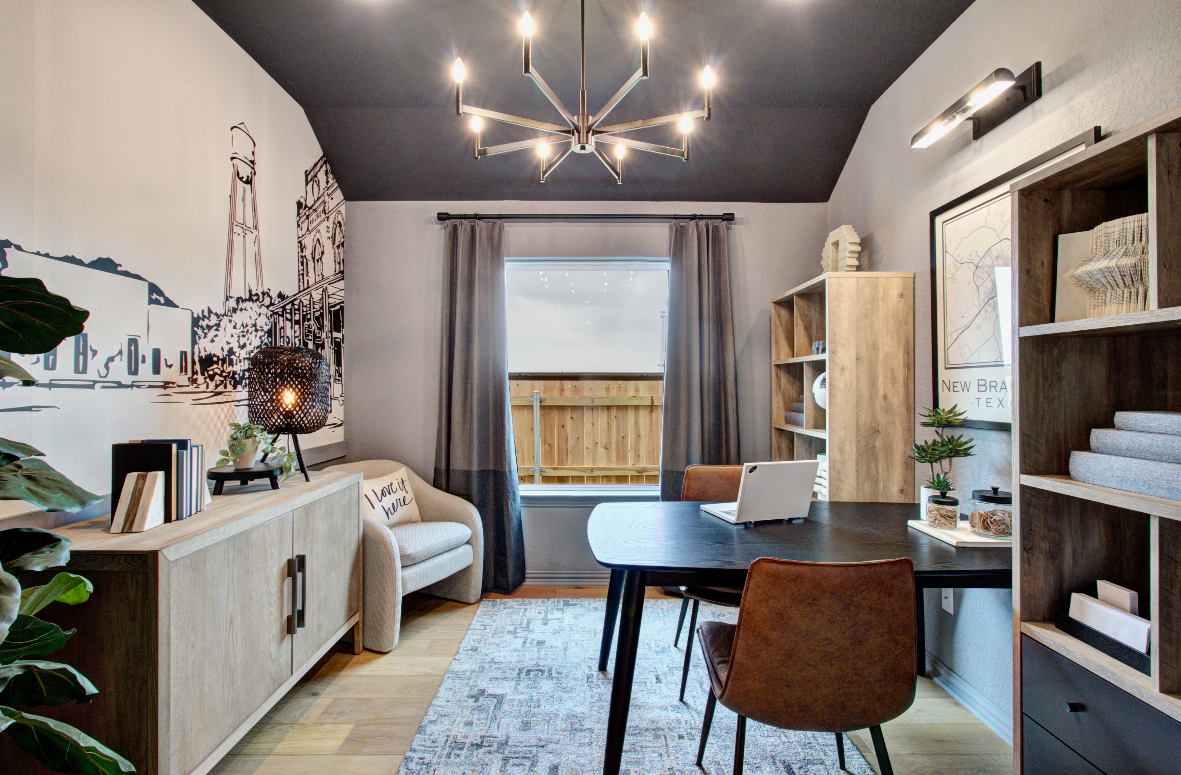 Home Office with Mural and Chandelier in Sunflower Ridge Elegant home office with sleek chandelier, mural wall, modern furniture in Sunflower Ridge community.