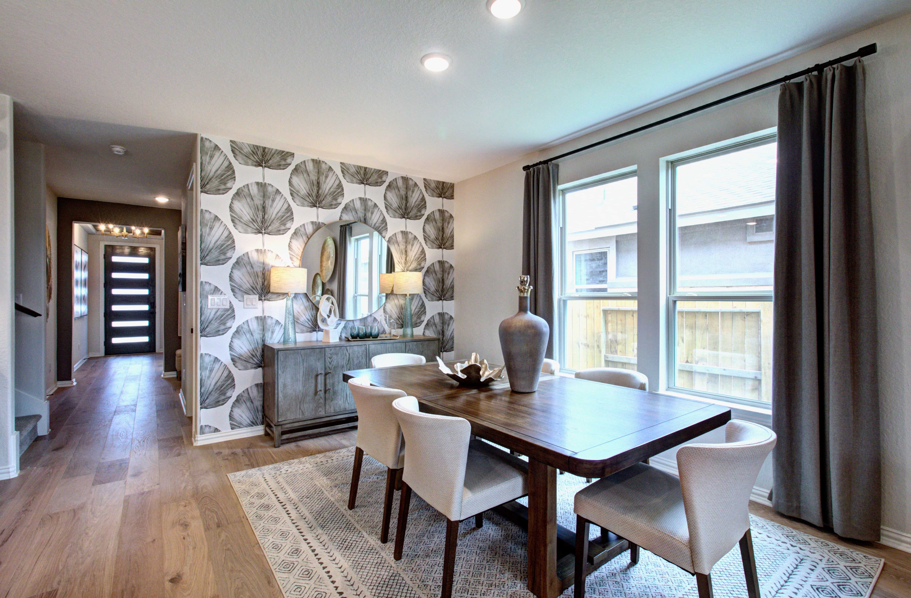 Elegant Dining Room in Meyer Ranch Enclave with Modern Decor Elegant dining room with patterned wallpaper, chic decor, wooden table, modern lighting in Meyer Ranch enclave.